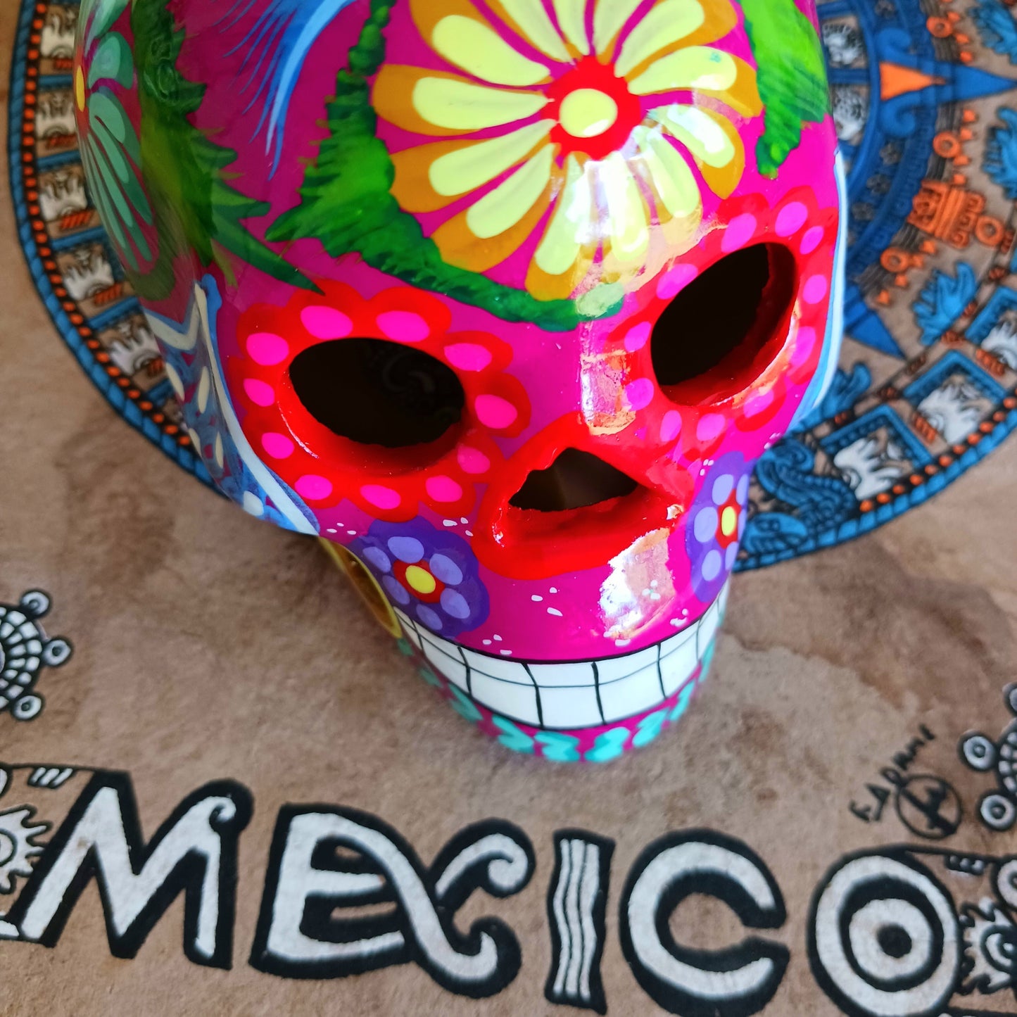 These fun ceramic sugar skull ornaments have been beautifully painted in bright colours and finished with a high shine glaze.&nbsp;

They are a popular item during Día de Los Muertos or Day of the Dead festivities, held in Mexico every November to celebrate welcoming the souls of their deceased relatives back for a time of food, drink and celebration.