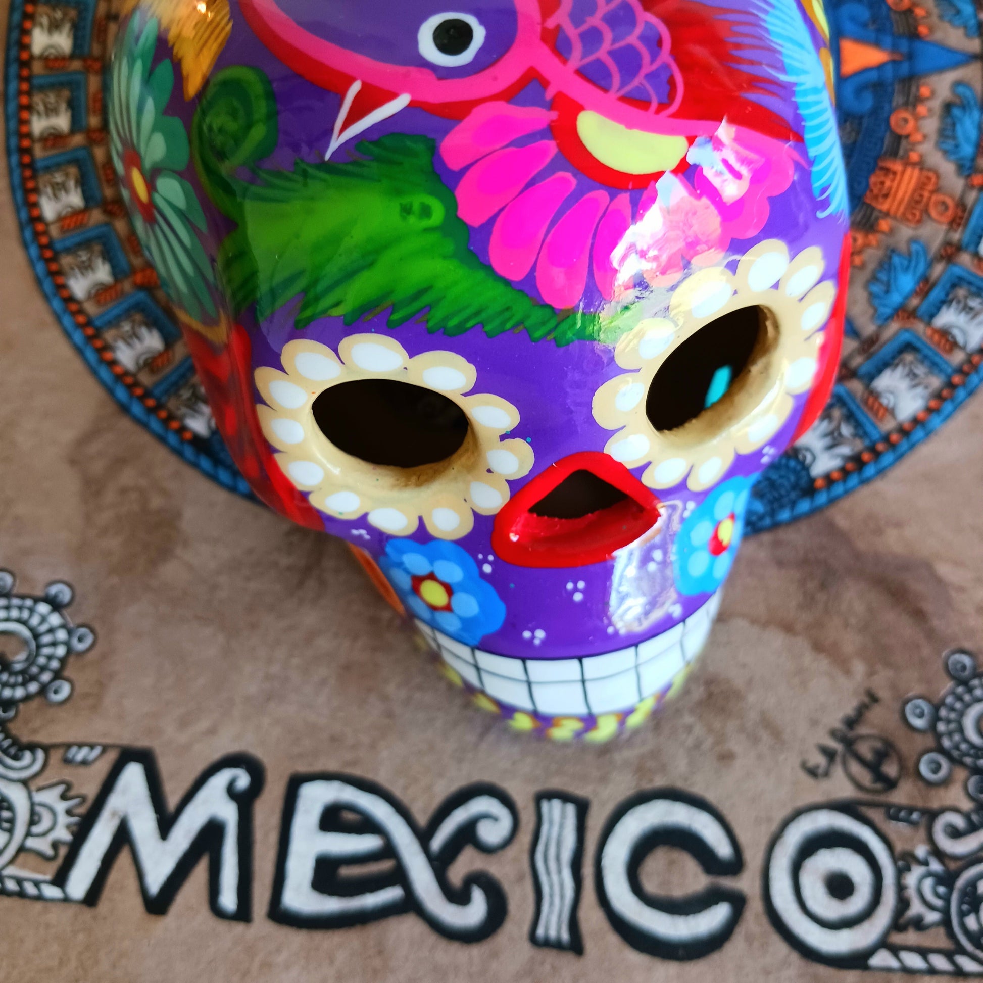 These fun ceramic sugar skull ornaments have been beautifully painted in bright colours and finished with a high shine glaze.&nbsp;

They are a popular item during Día de Los Muertos or Day of the Dead festivities, held in Mexico every November to celebrate welcoming the souls of their deceased relatives back for a time of food, drink and celebration.

These skulls are also make a bright edition to any home.