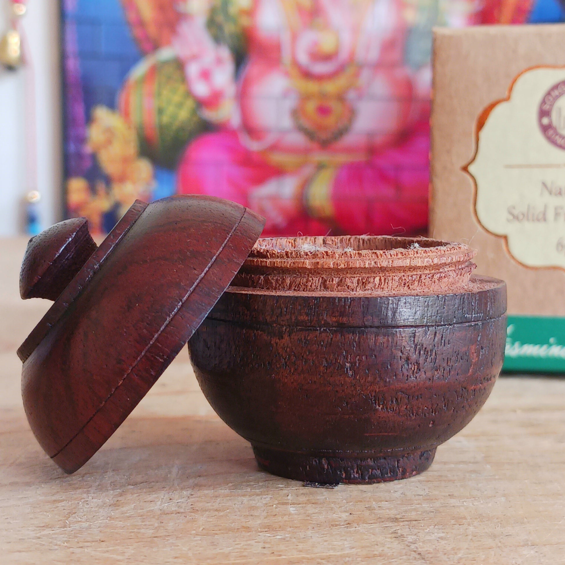 This natural solid Jasmine fragrance cream is presented in a beautiful little jar made by artisans from the best handpicked Indian rosewood bark. With natural colours and veins, each jar is a collector's item and no two pieces are exactly identical.