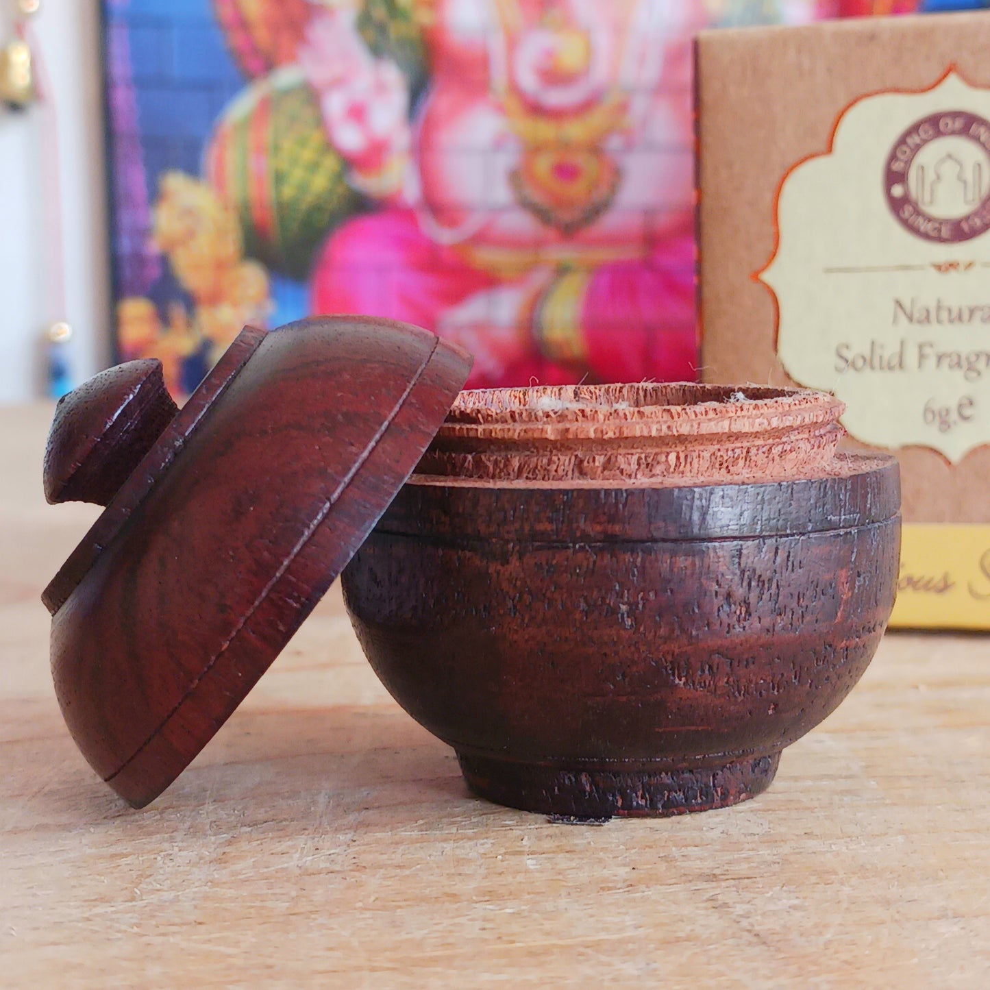 This natural solid Sandalwood fragrance cream is presented in a beautiful little jar made by artisans from the best handpicked Indian rosewood bark. With natural colours and veins, each jar is a collector's item and no two pieces are exactly identical.