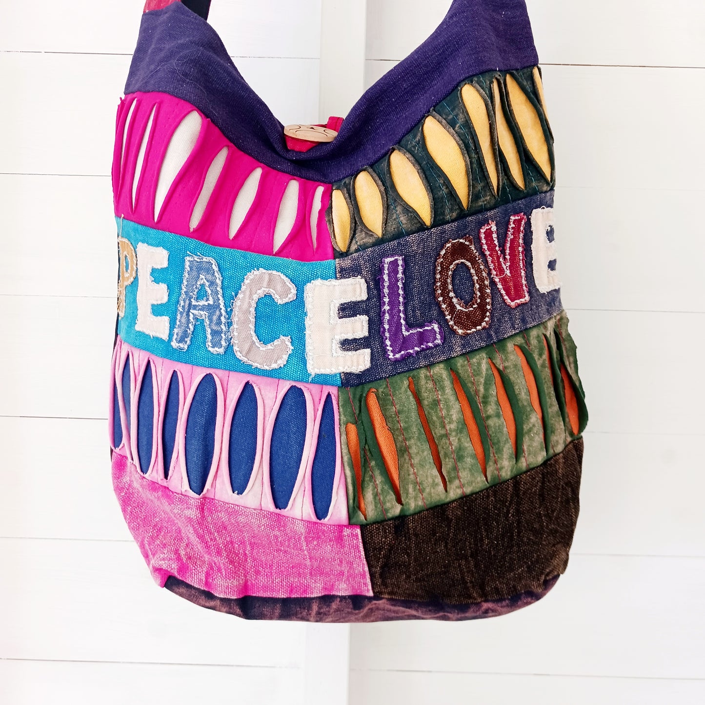 These cool Love &amp; Peace bags are made with vibrant colours and are wonderful quality, and the size is ideal for carrying personal belongings comfortably and perfect for days out. These bags are great to wear any time of the year.