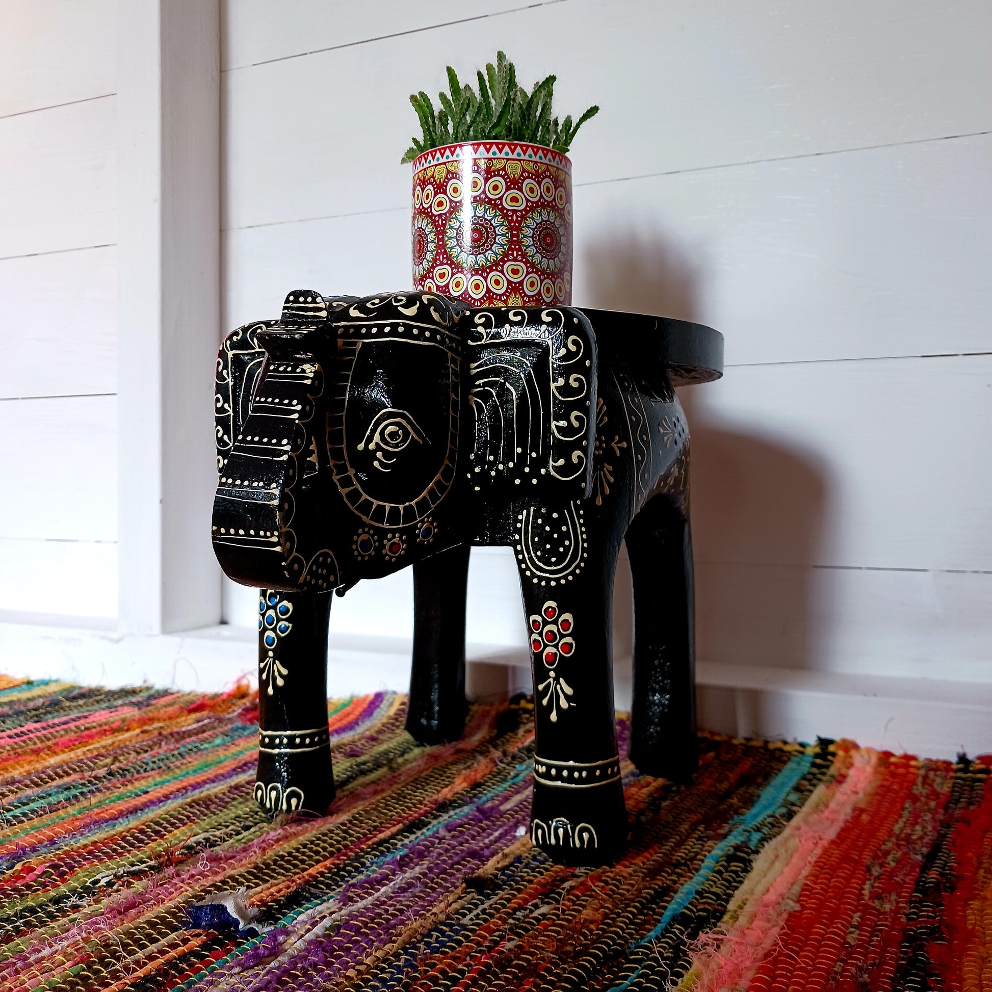 These beautifully hand painted footstools are shaped as elephants and decorated with traditional Indian designs.