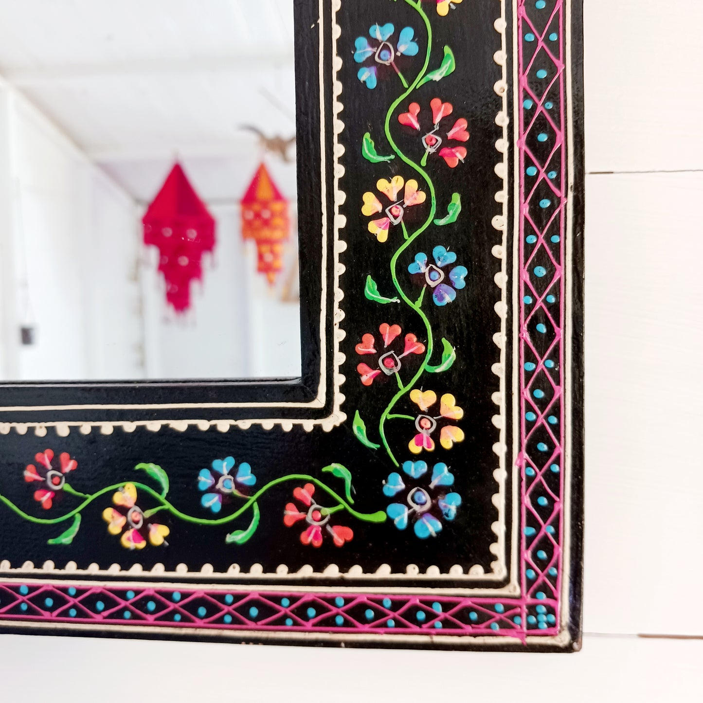 These beautiful Indian mirrors are made from sustainable mango wood and hand painted in a black floral design.