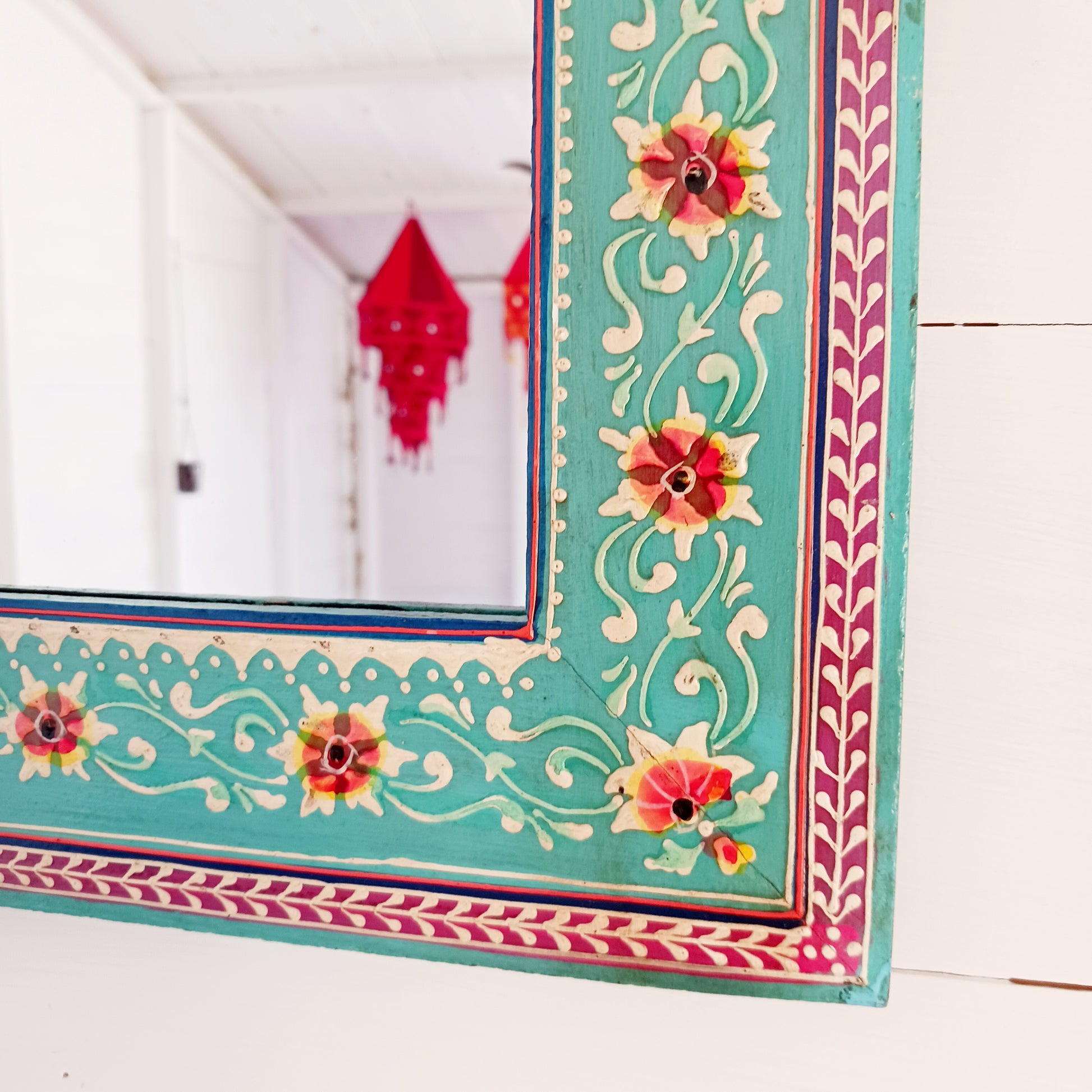 These beautiful Indian mirrors are made from sustainable mango wood and hand painted in a turquoise floral design.