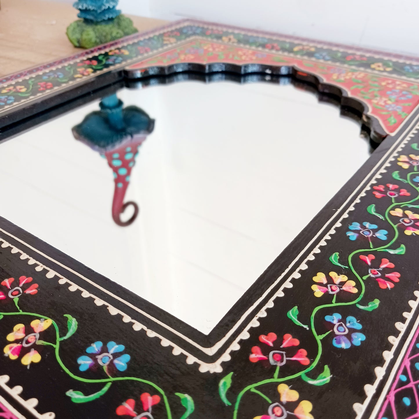 These beautiful Indian mirrors are made from sustainable mango wood and hand painted in a black floral design.