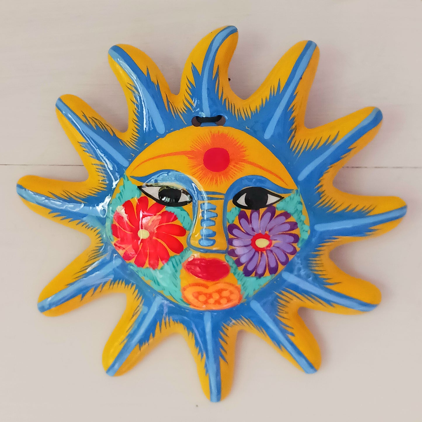 This sunny and vibrant wall plaque will get you smiling! It has been beautifully handpainted in a bright style traditional to Xalitla, a region of Guerrero, Mexico.