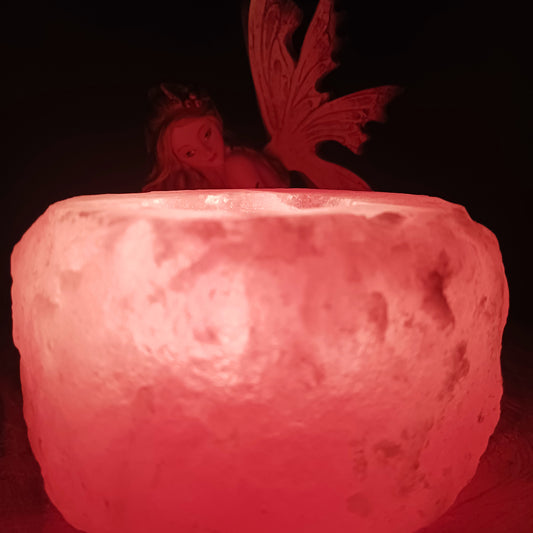 The tealight holders are made from chunks of Himalayan pink salt, which has a natural pink-red hue because of the minerals from which it’s formed. This gives off a soft, soothing pink glow when a tealight is shone through the rock.