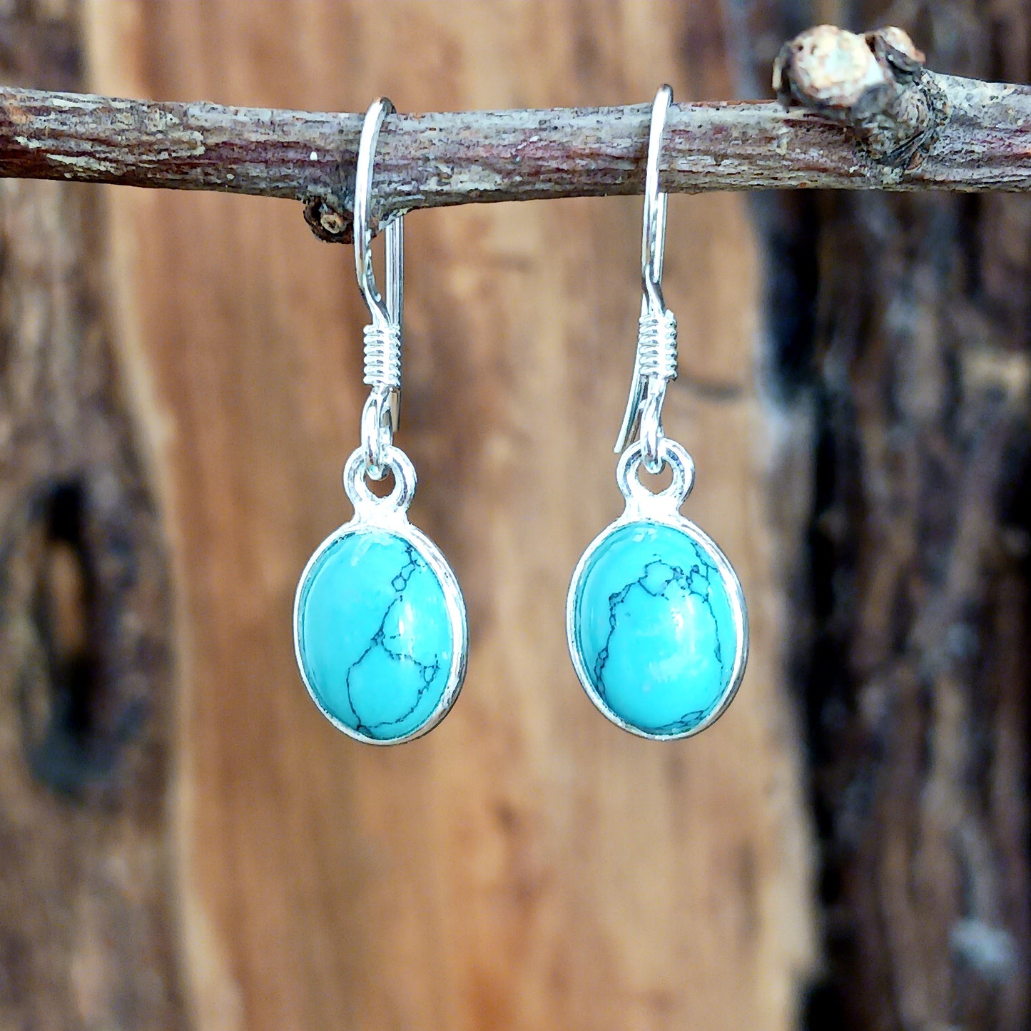 Discover the timeless beauty and healing properties of Turquoise with our 925 Silver Oval Earrings. Crafted from the oldest stone known to man, these earrings offer protection and a touch of elegance to any outfit. The delicate veining adds a unique charm to each pair. Gemstone size: 8mm x 10mm.