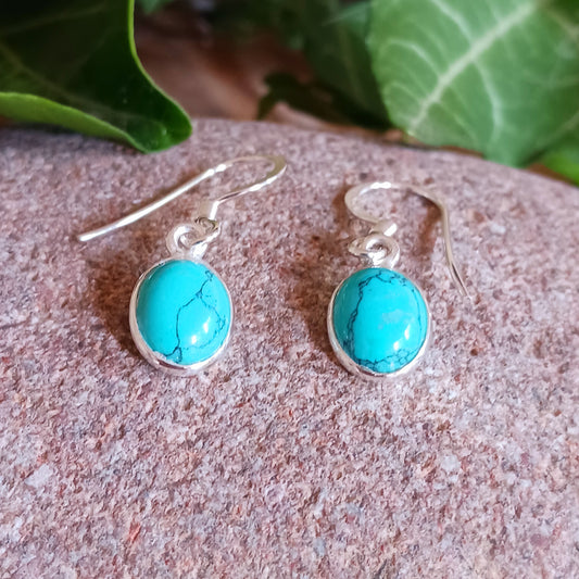 Discover the timeless beauty and healing properties of Turquoise with our 925 Silver Oval Earrings. Crafted from the oldest stone known to man, these earrings offer protection and a touch of elegance to any outfit. The delicate veining adds a unique charm to each pair. Gemstone size: 8mm x 10mm.