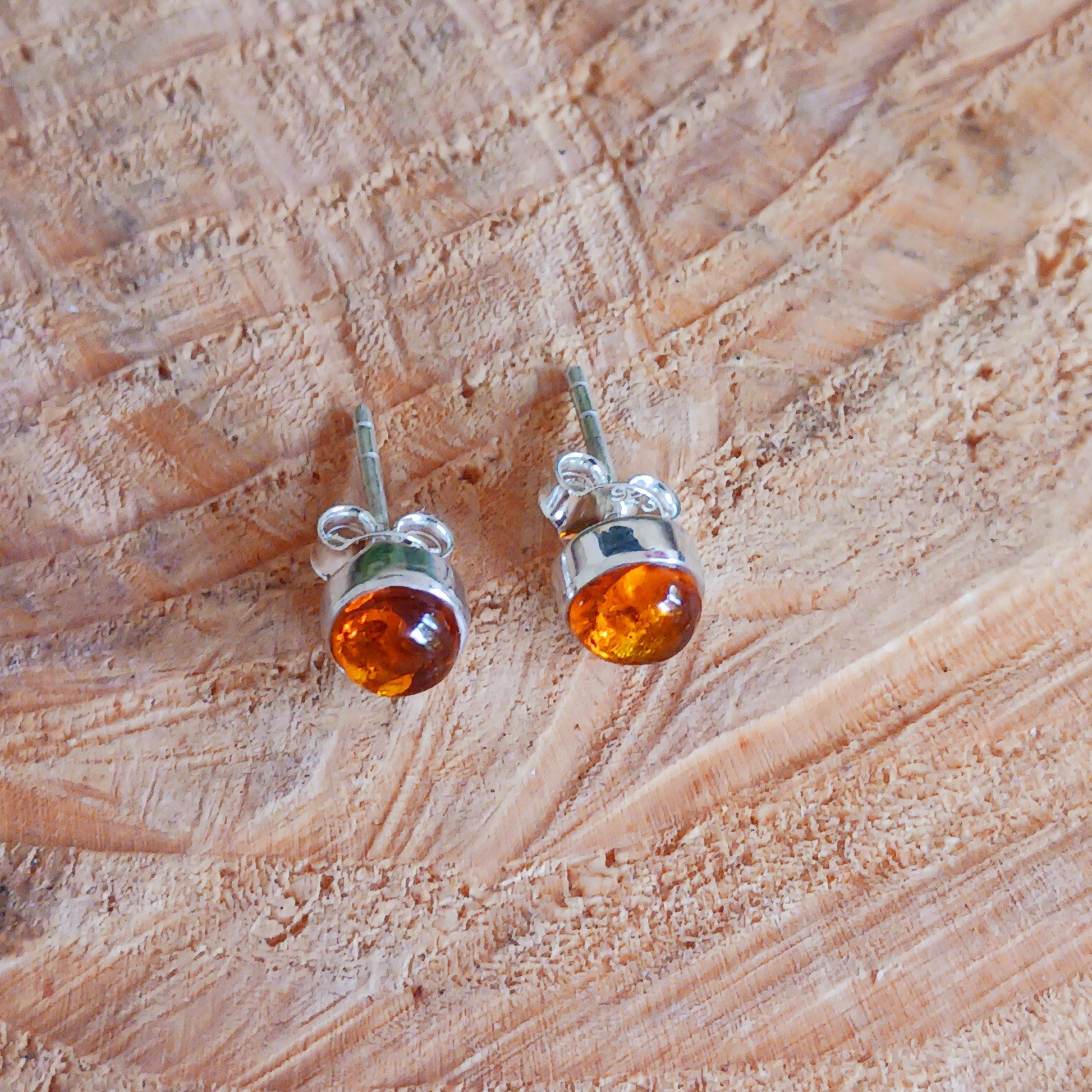 These perfect Silver Amber Stud earrings are minimal and modern jewellery box must-have!&nbsp;

Handcrafted with beautiful large Amber gemstones, the stones are set within simple sterling silver frames, adding a modern and elegant touch to the natural centrepiece.&nbsp; Each Amber gemstone boasts a classic cut, with dome top and perfect polish.&nbsp;

Approx size 5mm