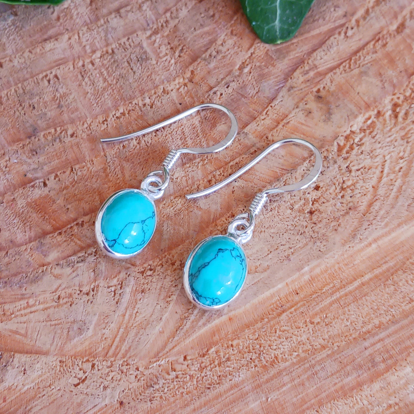 Discover the timeless beauty and healing properties of Turquoise with our 925 Silver Oval Earrings. Crafted from the oldest stone known to man, these earrings offer protection and a touch of elegance to any outfit. The delicate veining adds a unique charm to each pair. Gemstone size: 8mm x 10mm.