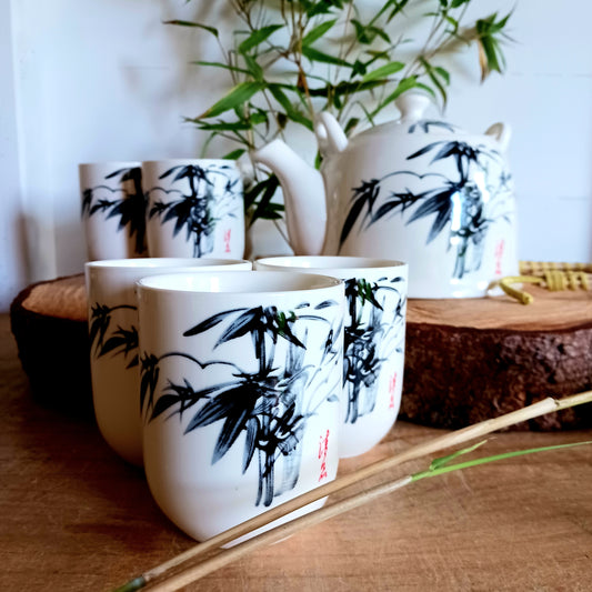 This beautiful Oriental Herbal Teapot Set is made in a ceramic white stone Oriental bamboo design.  Packed in a gift box, a teapot with a metal strainer in the lid, a detachable handle and six matching little cups.