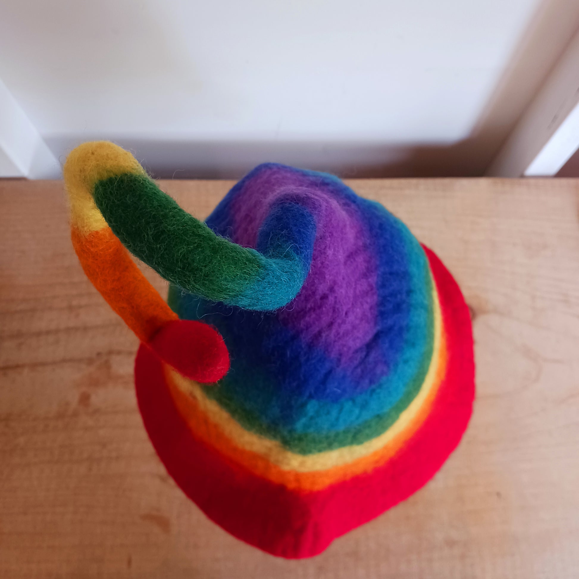 Fantastically fun, furiously fuzzy felt hats, all handmade in Nepal. These hats are made in wonderful and vivid rainbow stripes, and have a thin wire in the top part for bending to any crazy pixie position you like, perfect for being spotted in a crowd!