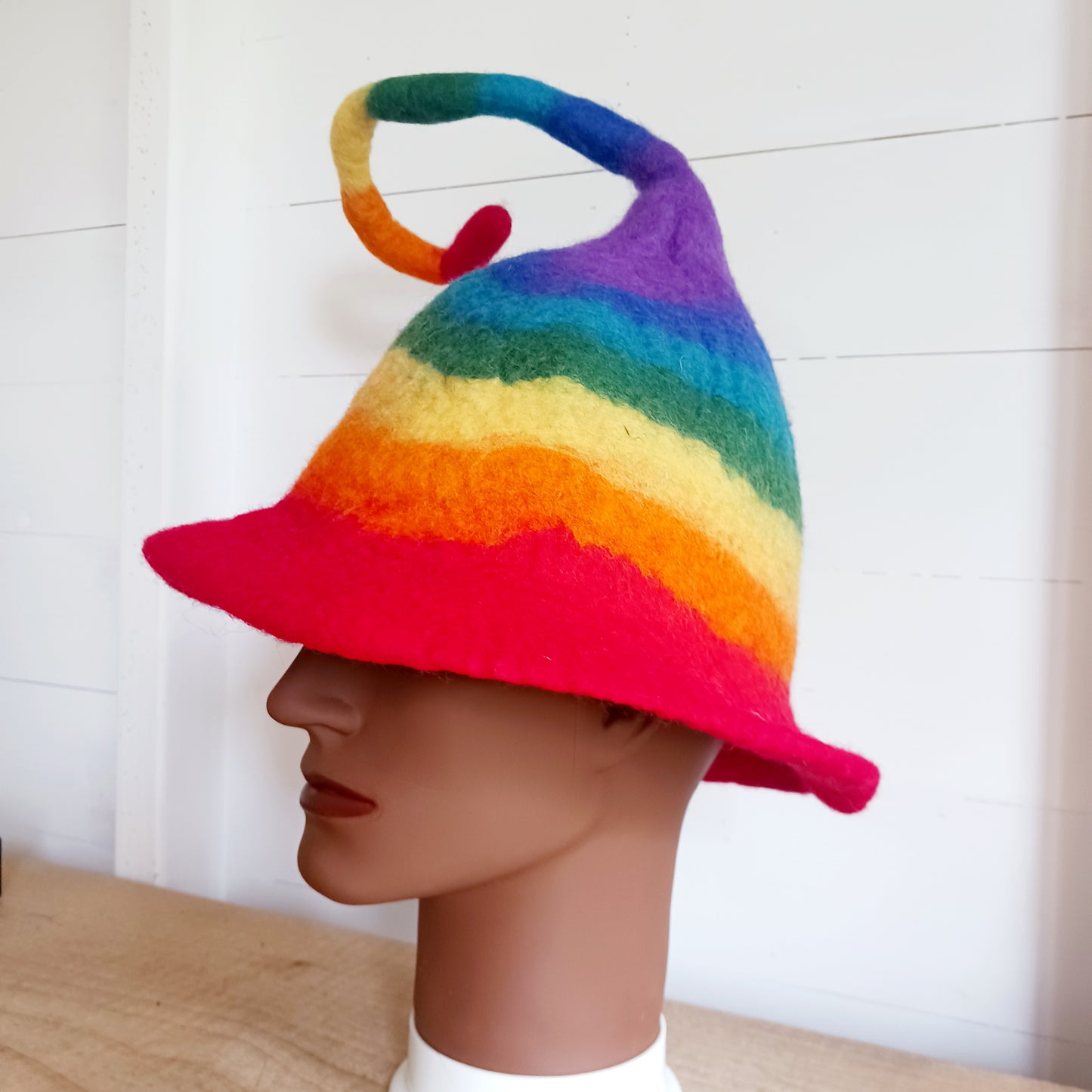 Fantastically fun, furiously fuzzy felt hats, all handmade in Nepal. These hats are made in wonderful and vivid rainbow stripes, and have a thin wire in the top part for bending to any crazy pixie position you like, perfect for being spotted in a crowd!