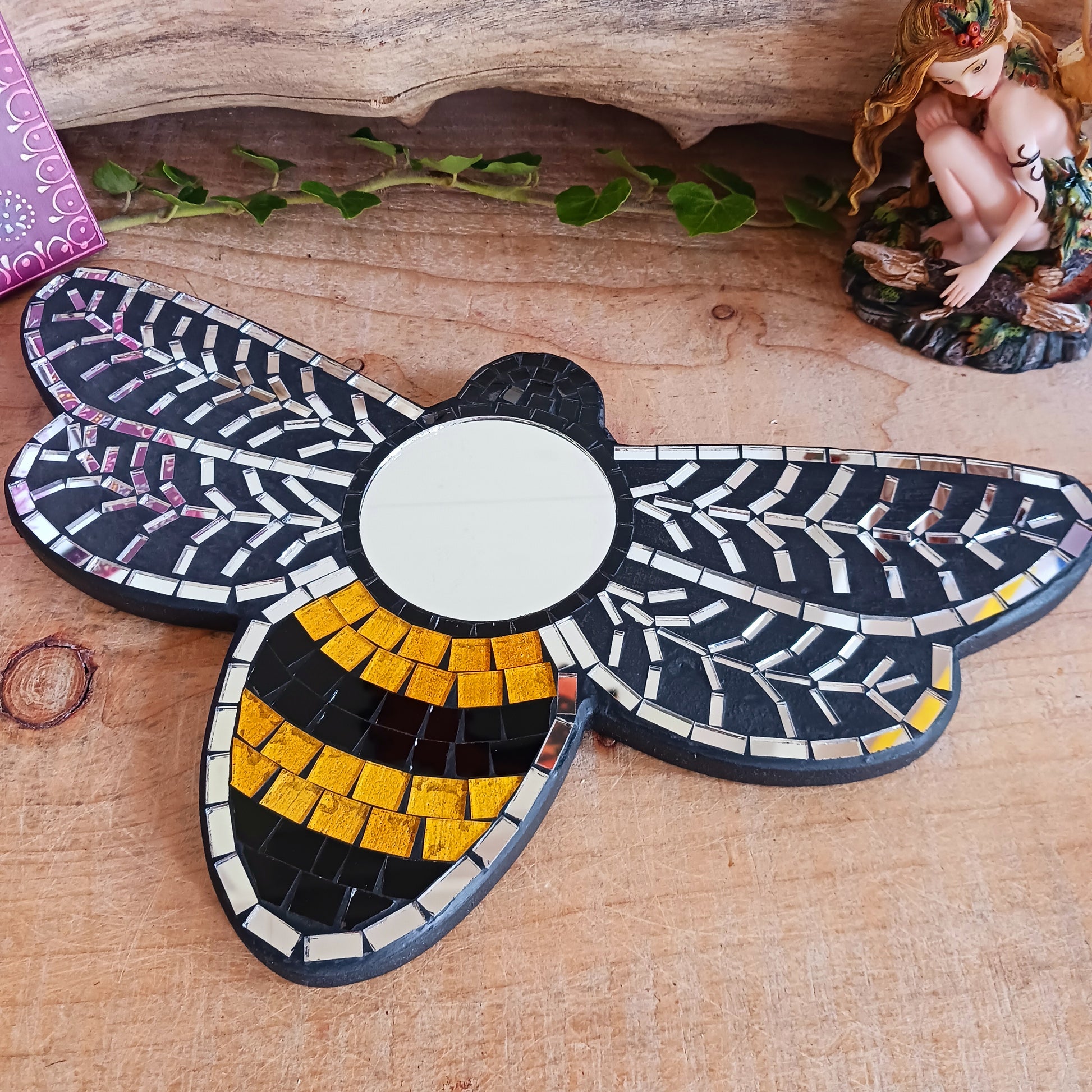 This lovely little unique mirror is made from small pieces of coloured glass that have been arranged in a busy bee design. This unique mosaic mirror has been handmade in Bali.