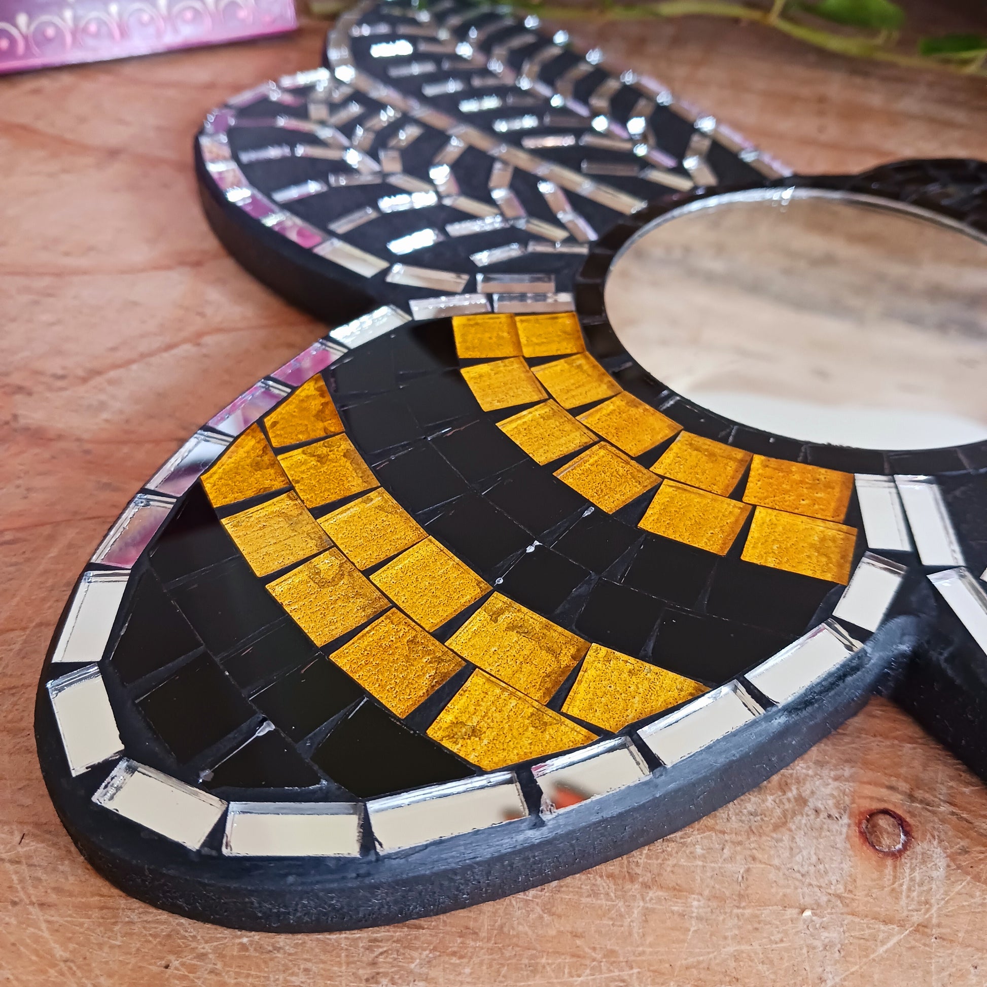 This lovely little unique mirror is made from small pieces of coloured glass that have been arranged in a busy bee design. This unique mosaic mirror has been handmade in Bali.