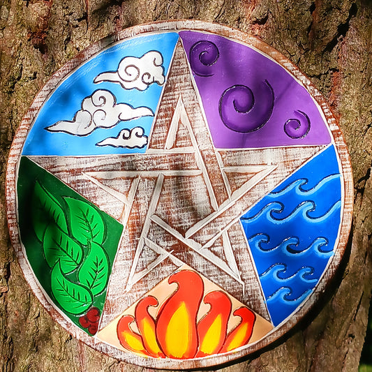 This beautifully finished mango wood wall plaque depicts the five great elements – Earth, Water, Fire, Air and Ether. These hand painted, brightly coloured elements are tied together with a central pentagram, with a natural whitewash finish.