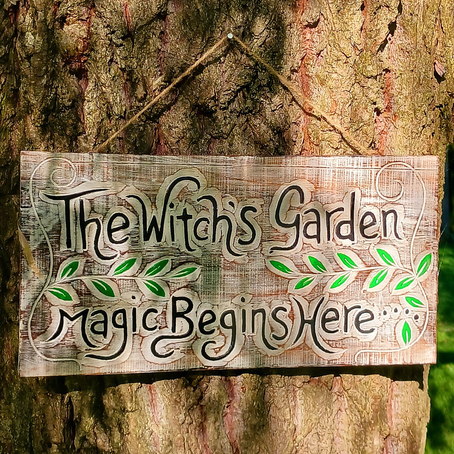 This solid wooden plaque has been hand etched and painted with the inscription: "The Witch's Garden. Magic Begins Here."