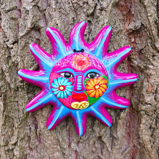 This sunny and vibrant wall plaque will get you smiling! It has been beautifully hand painted in a bright style traditional to Xalitla, a region of Guerrero, Mexico. A striking glaze adds to the bold design. It has two holes which can be used to add a hanging loop for an easy display.