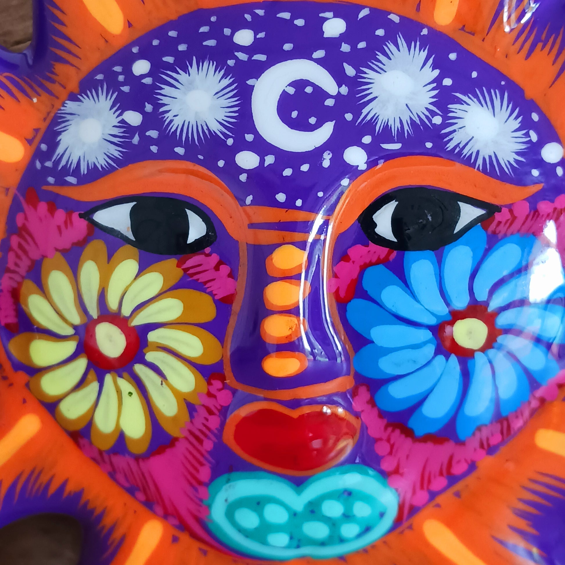 This sunny and vibrant wall plaque will get you smiling! It has been beautifully hand painted in a bright style traditional to Xalitla, a region of Guerrero, Mexico. A striking glaze adds to the bold design. It has two holes which can be used to add a hanging loop for an easy display.