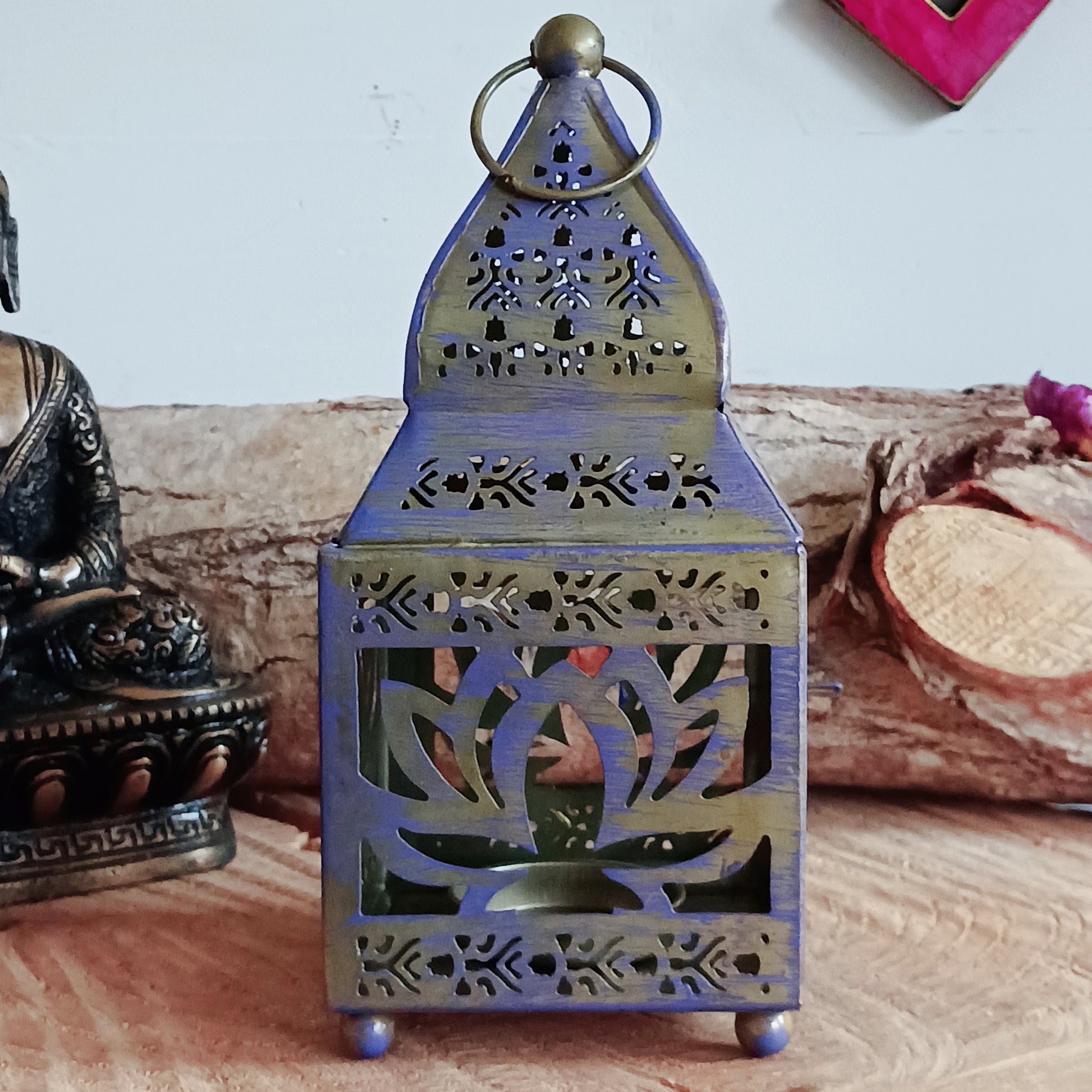 This pretty oriental Lotus lantern is finished with a purple vintage look. It can either be free-standing or hung up. A tea light can be placed through the door on one of the sides.