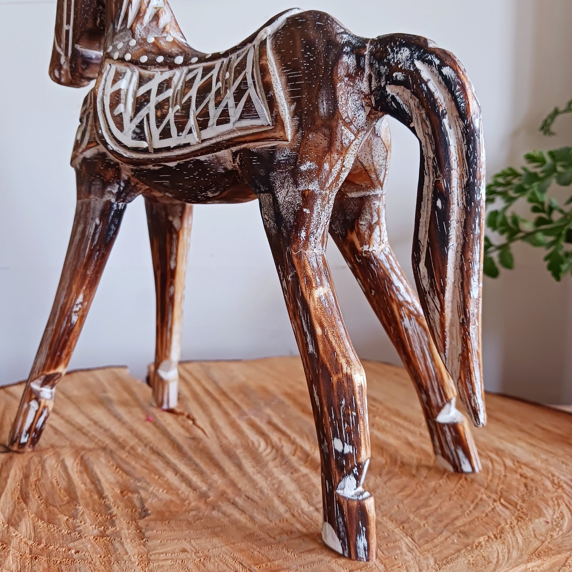 Handcrafted from albasia wood, this antique horse features intricate carvings and a beautiful distressed finish, exuding a timeless charm that appeals to all. Ideal for adding a touch of vintage elegance to any space, this piece is versatile enough to complement various interior styles. Its compact size ensures it fits seamlessly on shelves, mantels, or as part of a centerpiece.