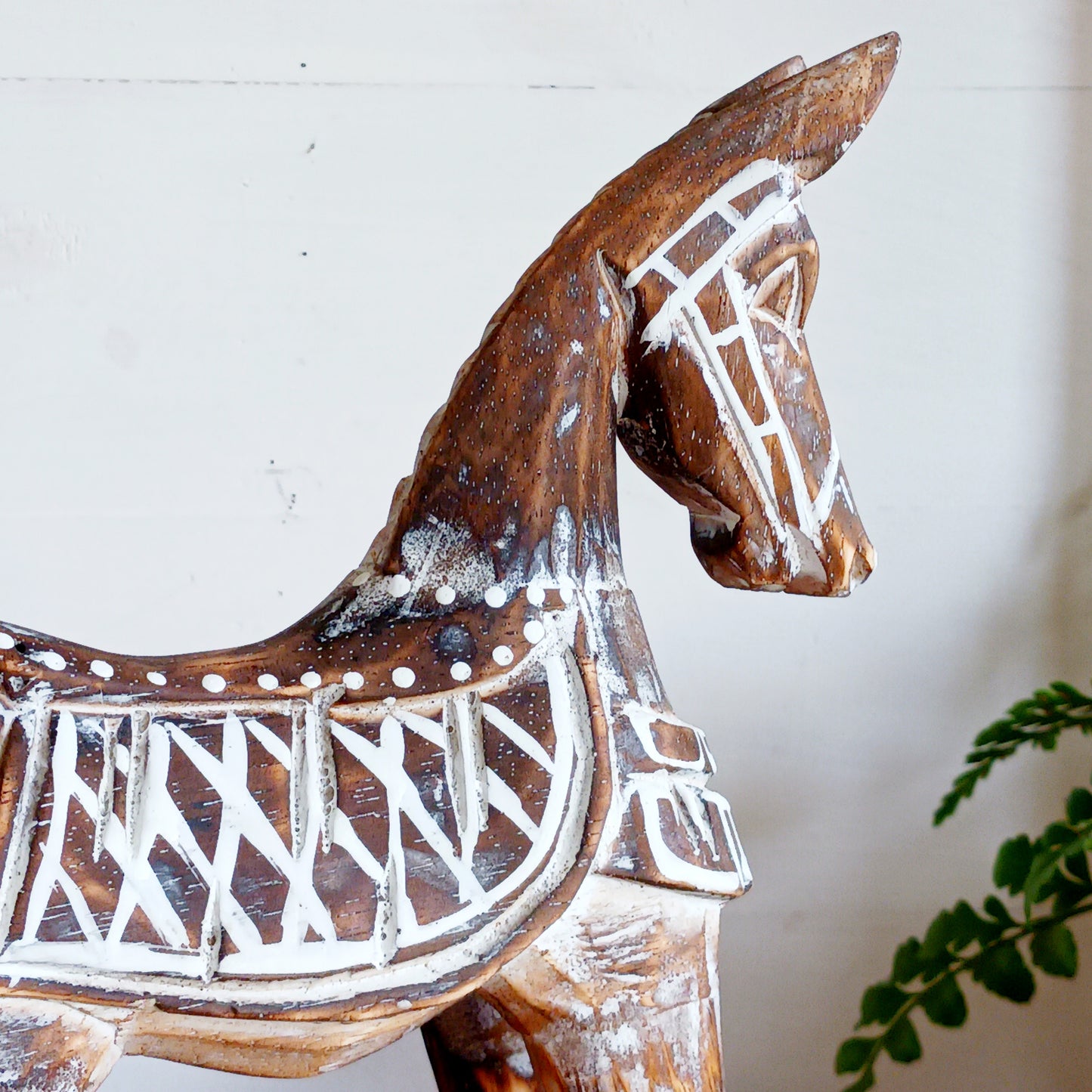 Handcrafted from albasia wood, this antique horse features intricate carvings and a beautiful distressed finish, exuding a timeless charm that appeals to all. Ideal for adding a touch of vintage elegance to any space, this piece is versatile enough to complement various interior styles. Its compact size ensures it fits seamlessly on shelves, mantels, or as part of a centerpiece.