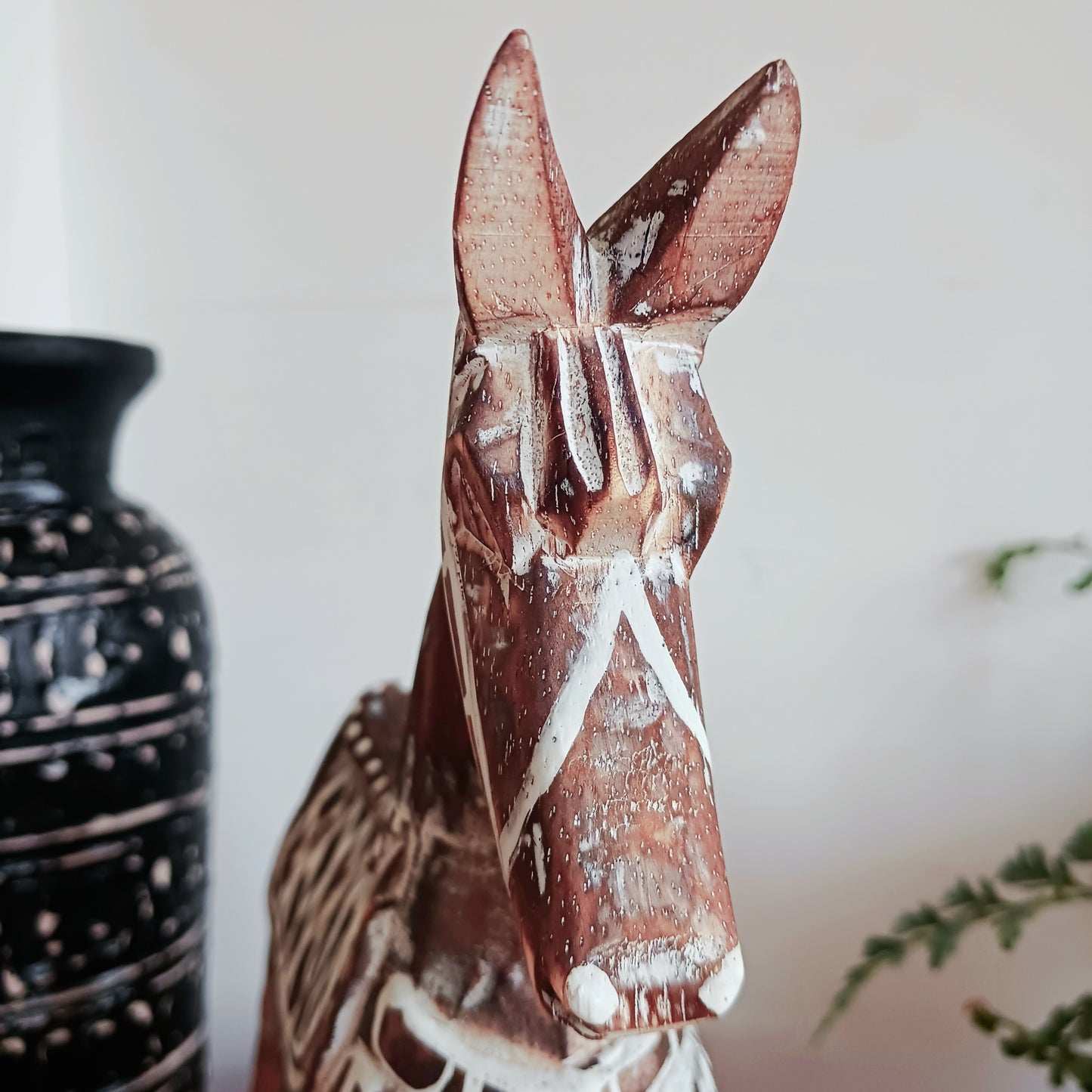 Handcrafted from albasia wood, this antique horse features intricate carvings and a beautiful distressed finish, exuding a timeless charm that appeals to all. Ideal for adding a touch of vintage elegance to any space, this piece is versatile enough to complement various interior styles. Its compact size ensures it fits seamlessly on shelves, mantels, or as part of a centerpiece.