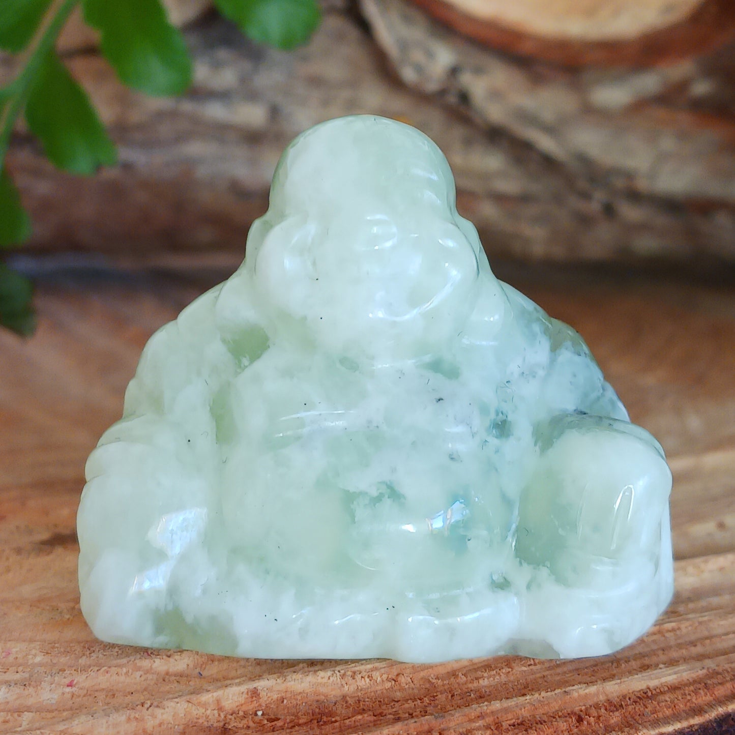 This beautiful miniature handcarved Laughing Buddha has been crafted from genuine Jade Gemstone. This gemstone Buddha is a jolly and elegant symbol of peace, spiritual growth, and inner clarity.