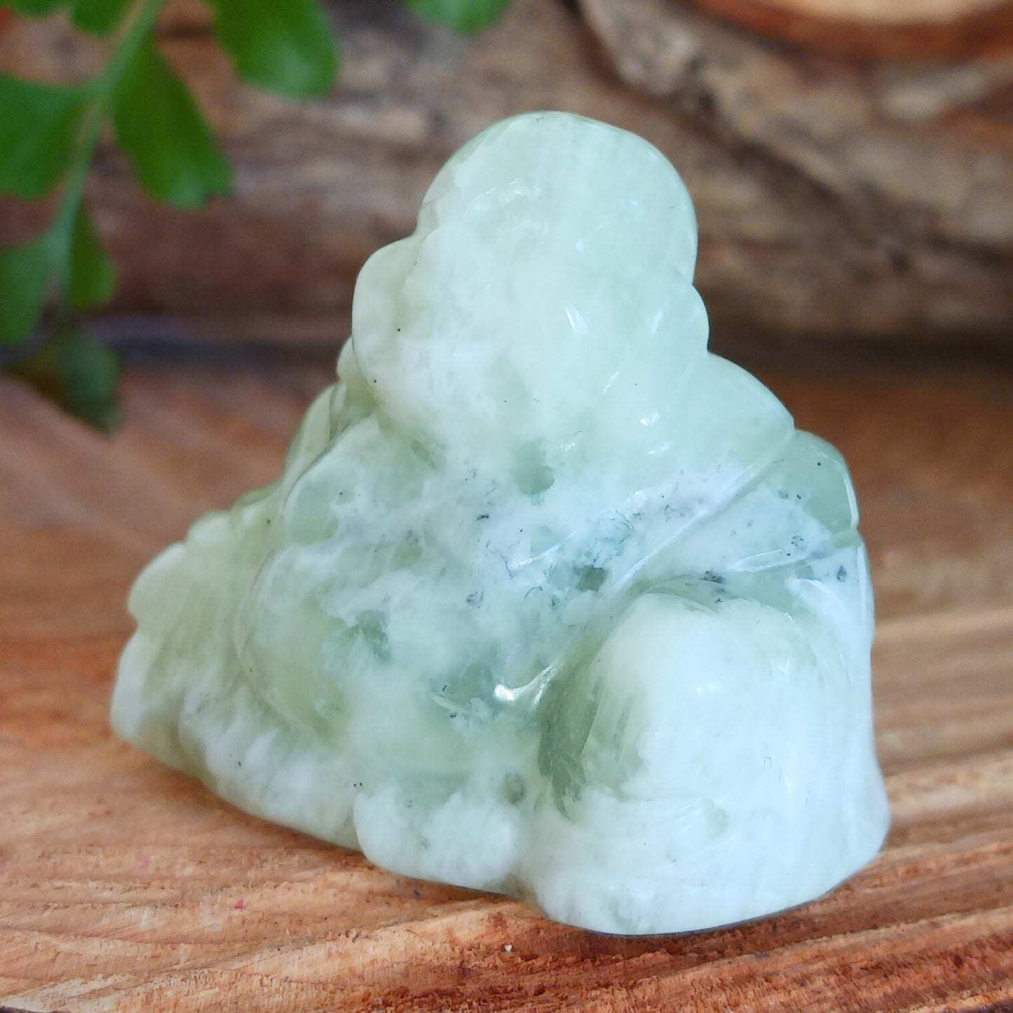 This beautiful miniature handcarved Laughing Buddha has been crafted from genuine Jade Gemstone. This gemstone Buddha is a jolly and elegant symbol of peace, spiritual growth, and inner clarity.