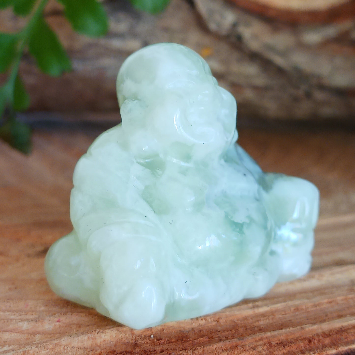 This beautiful miniature handcarved Laughing Buddha has been crafted from genuine Jade Gemstone. This gemstone Buddha is a jolly and elegant symbol of peace, spiritual growth, and inner clarity.