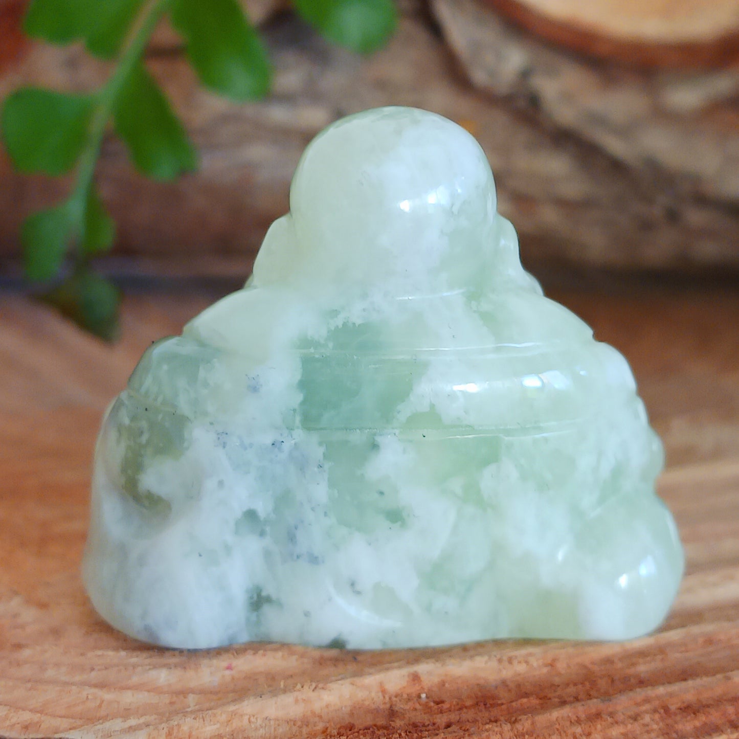 This beautiful miniature handcarved Laughing Buddha has been crafted from genuine Jade Gemstone. This gemstone Buddha is a jolly and elegant symbol of peace, spiritual growth, and inner clarity.