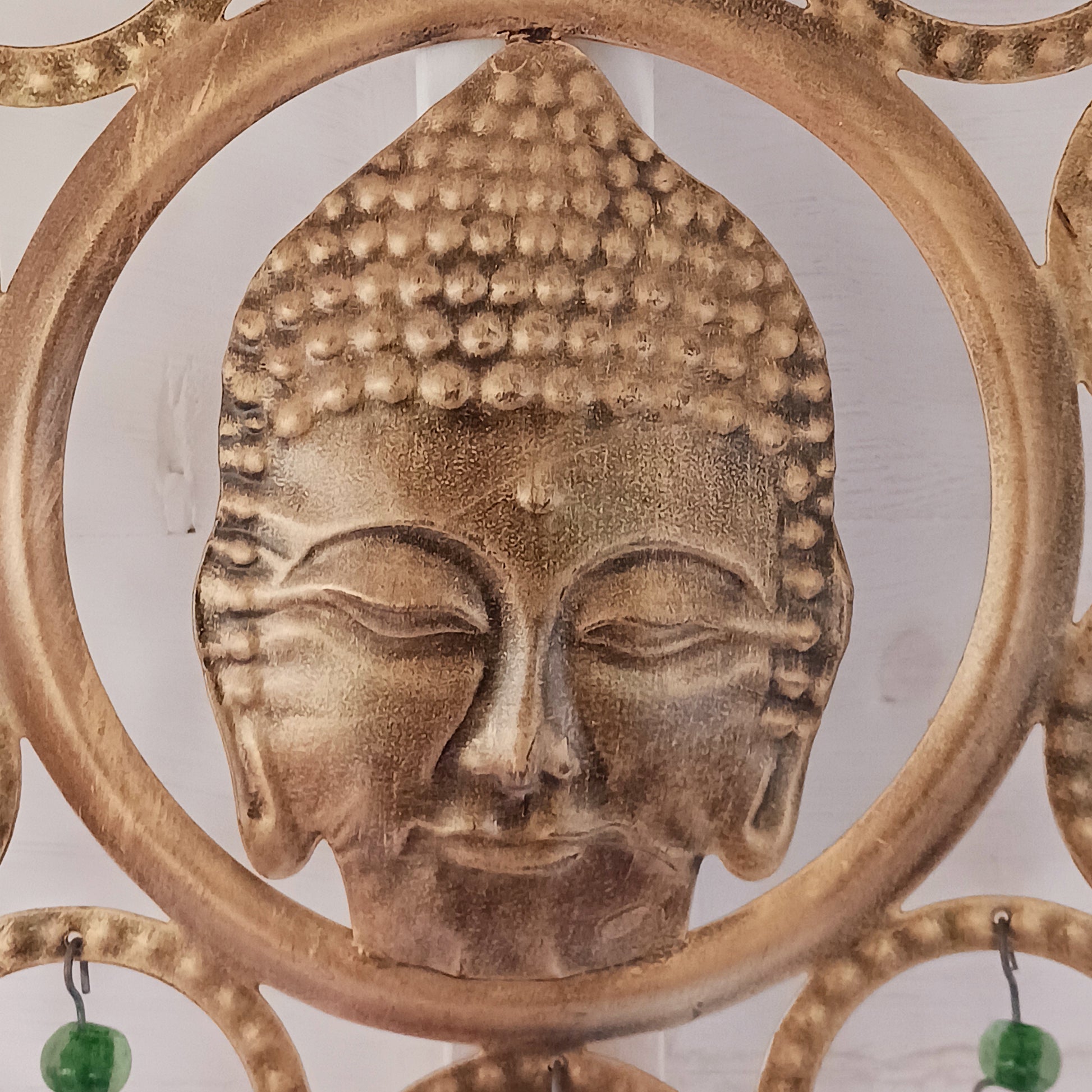 Enhance your living space with this beautiful large Buddha face 15 bell chimes.  This lovely brass decoration exudes serenity and spiritual charm. An intricate piece featuring a serene Buddha face surrounded by delicate circular accents and vibrant, colourful beads. With 15 brass bells, this chime creates a harmonious, soothing sound, making it ideal for both indoor and outdoor spaces.