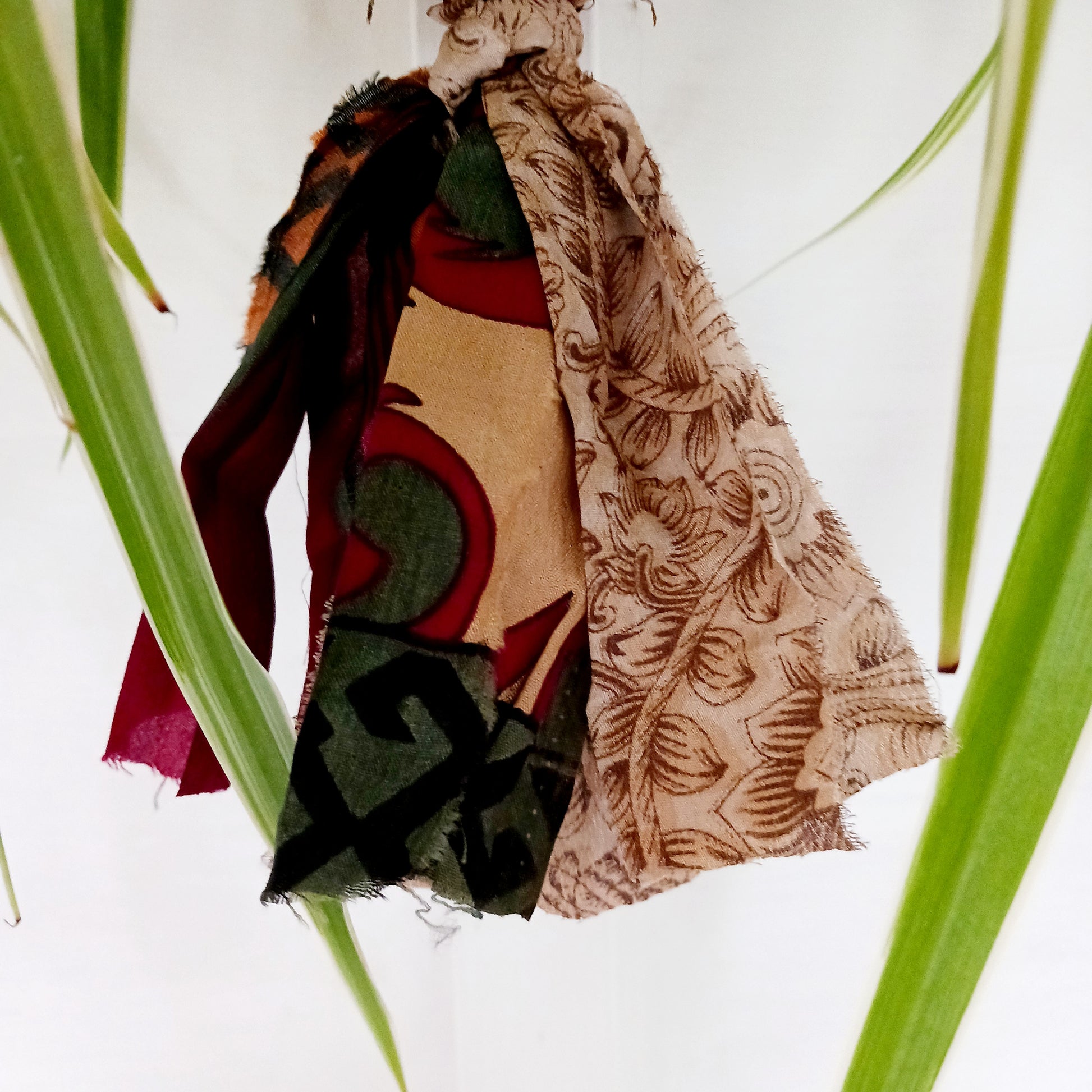 These lovely handmade sari plant hangers will add a splash of colour and boho chic to your home. Made from scraps of used sari, their simple design ensures that no fabric is wasted but is re-purposed into an elegant product. They will fit around most sized pots and features a strong metal ring for hanging.