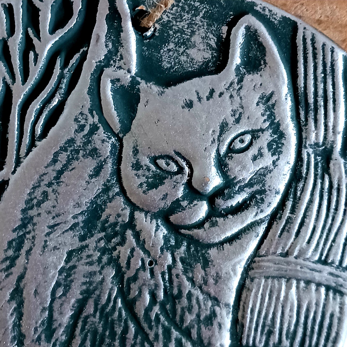 This stunning terracotta wall plaque has a silver-like finish with Lisa Parker's 'A Brush With Magic' artwork featuring a cat and witch's broom.