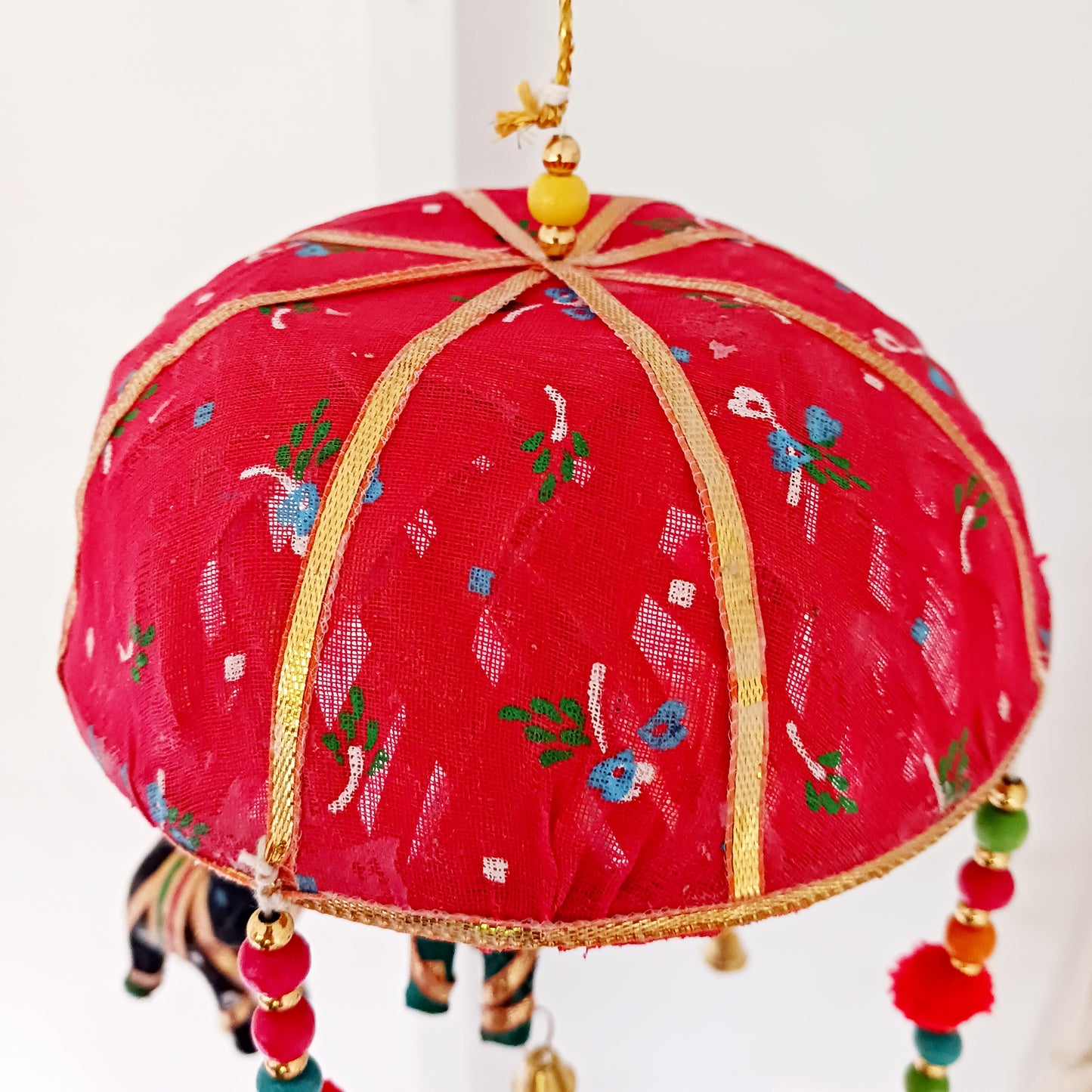 This colourful and playful mobile has five elephants and small tinkling bells at the ends. Ideal to hang in a child's bedroom or playroom.