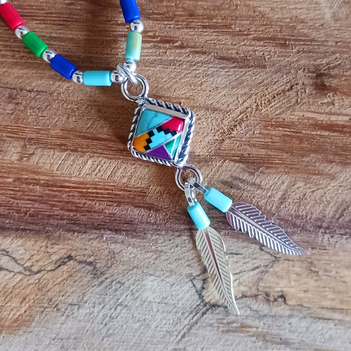 This stunning Aztec Necklace is both chic and cool. It has liquid silver chain with Aztec beads, the centrepiece is an Aztec diamond and from this hang two silver feathers, a symbol of warrior strength. 