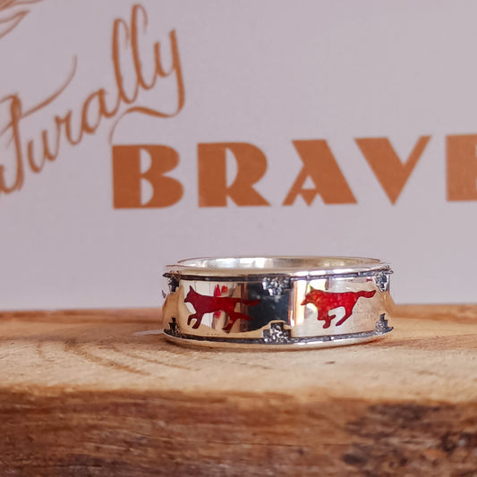 This solid sterling silver ring features a coral running wolf around the band. Southwestern Native-made Zuni jewellery embodies the rich cultural heritage and craftsmanship of the Zuni people, renowned for their intricate designs and meticulous attention to detail. Each piece is a testament to centuries-old traditions, handcrafted by skilled artisans who honor their ancestral techniques.