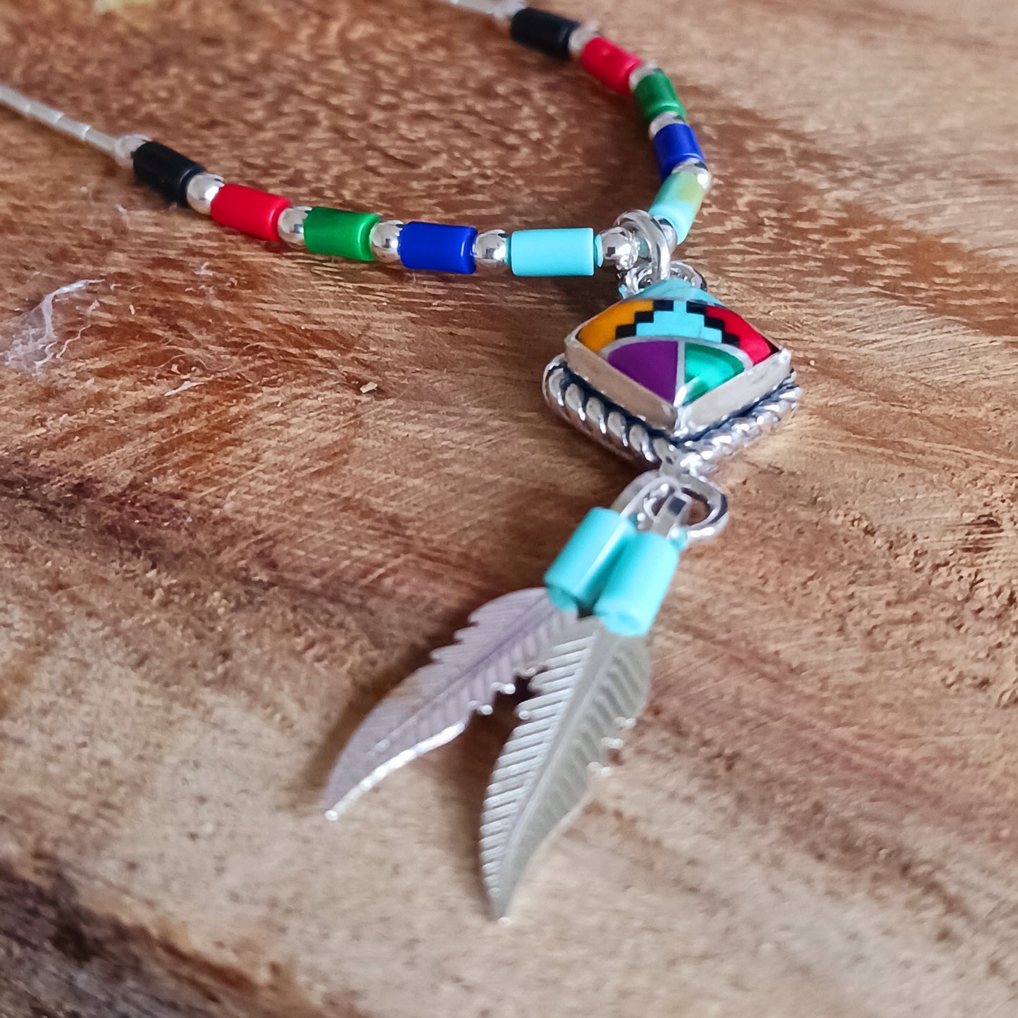 This stunning Aztec Necklace is both chic and cool. It has liquid silver chain with Aztec beads, the centrepiece is an Aztec diamond and from this hang two silver feathers, a symbol of warrior strength. 