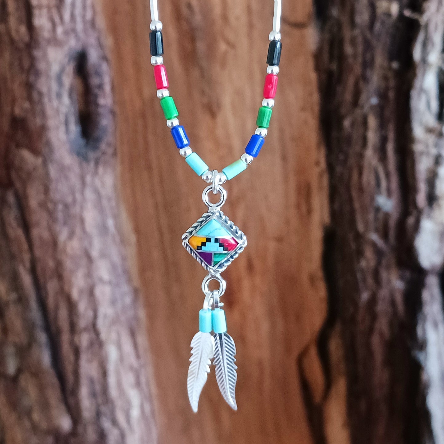 This stunning Aztec Necklace is both chic and cool. It has liquid silver chain with Aztec beads, the centrepiece is an Aztec diamond and from this hang two silver feathers, a symbol of warrior strength. 