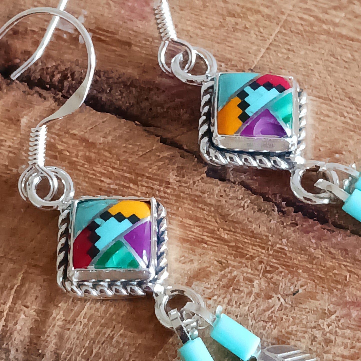 These stunning Aztec Earrings are both chic and cool. They feature a multicoloured Aztec diamond with rope surround, two silver feathers, on sterling silver ear wires.