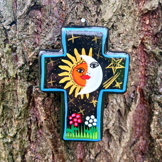 This bold handpainted Mexican cross has a striking glaze to further enhance the vibrant design of a solar and lunar eclipse.