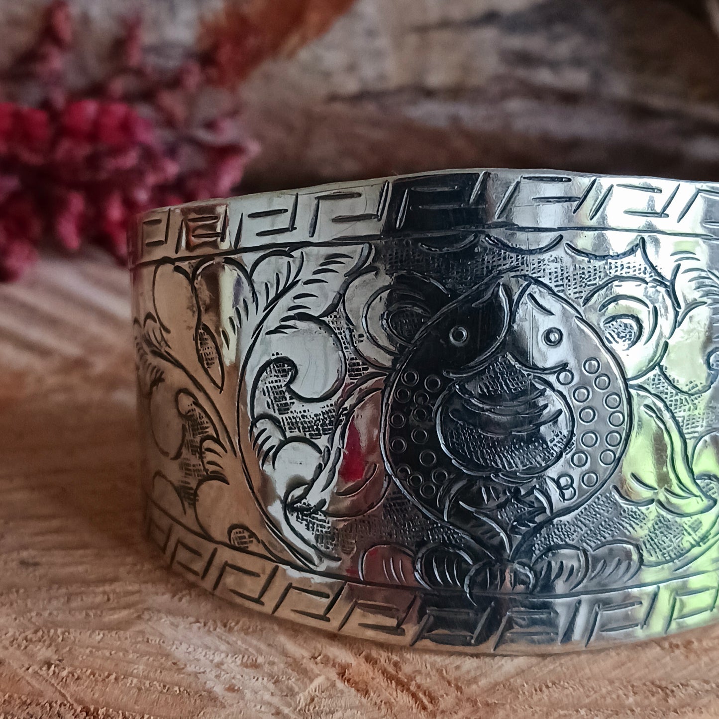 Handcrafted from Tibetan white metal, this elegant bracelet is delicately hand-etched with the Two Golden Fish - one of the eight Buddhist Auspicious symbols.