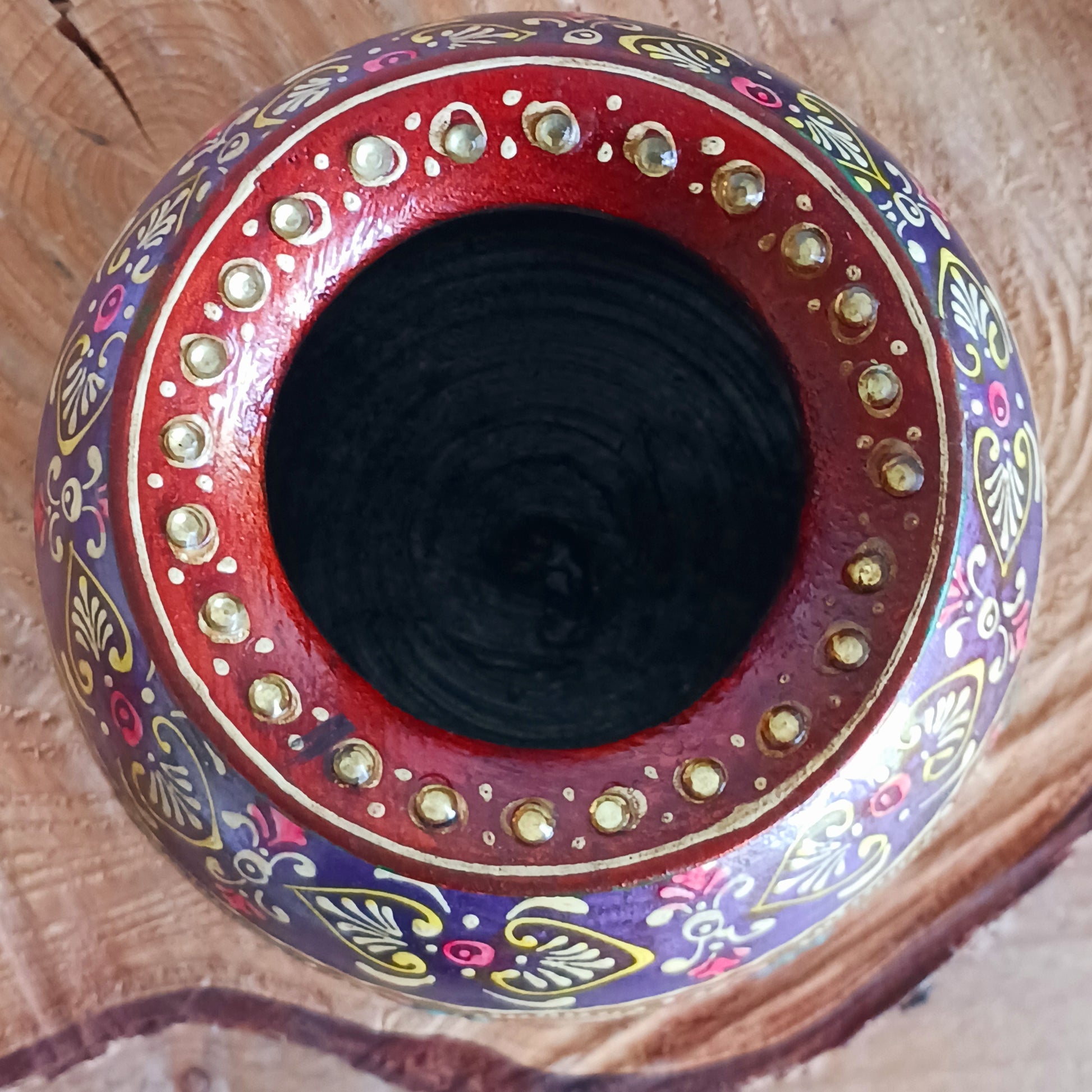 This decorative vintage style wooden pot has a detailed hand painted design. The attractive rich colour combination is set off with a pretty gem embellishment, adding texture and visual delight. An impressive entrance feature as ornamental storage or fill with dried grasses for an organic, changeable room feature.