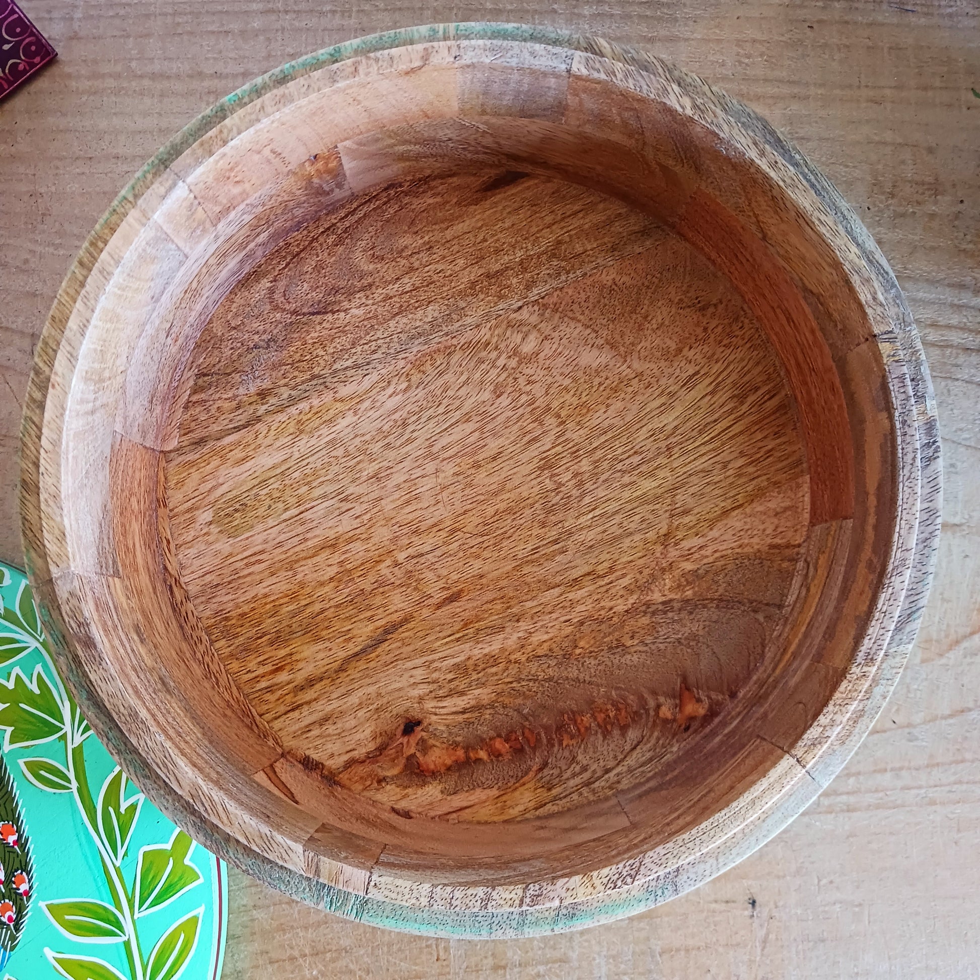 This beautiful large turquoise round Indian wooden box has been hand painted in a peacock design on the pull-off lid. It has a small round gold coloured central knob. Green leaves and pink flowers complete an appealing design.