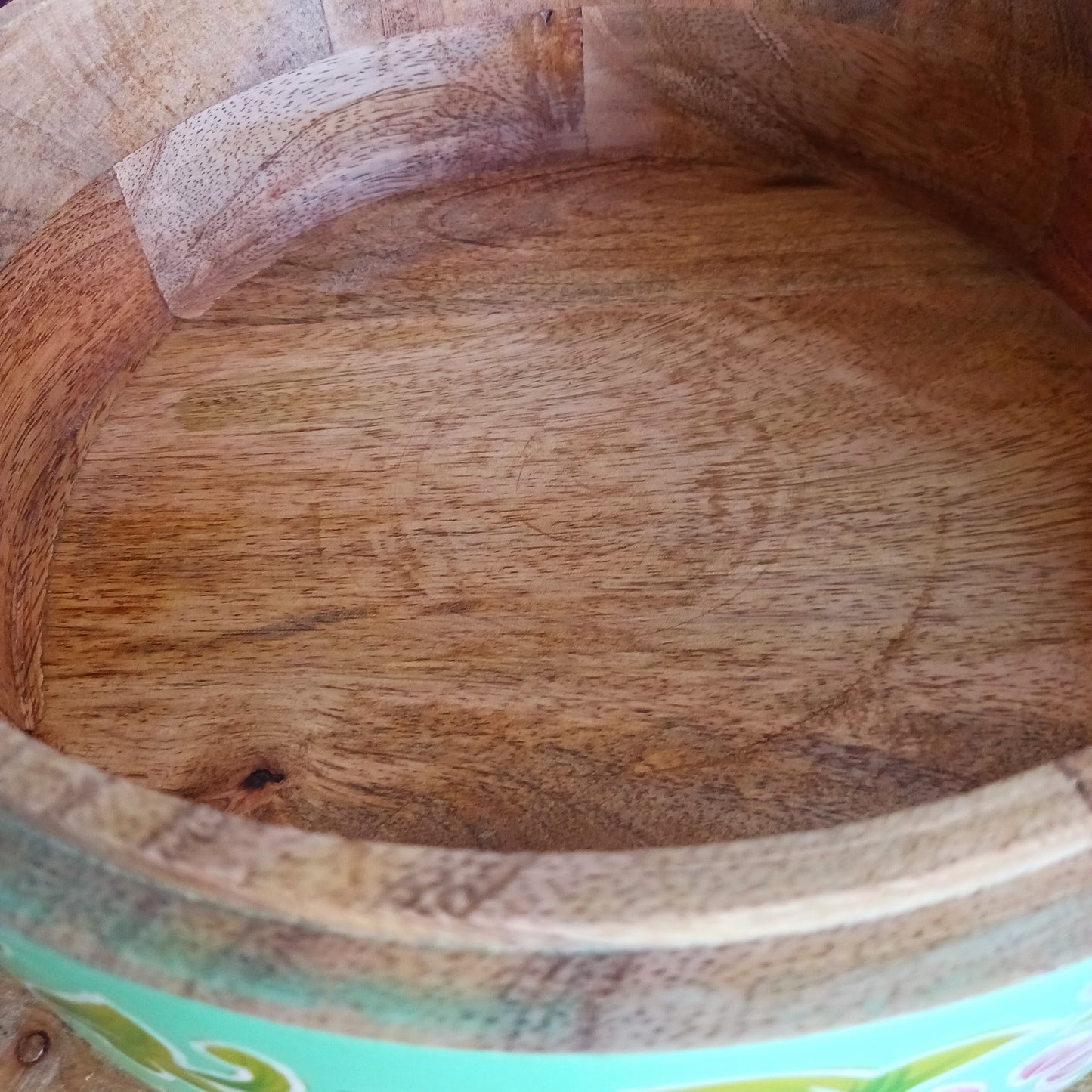 This beautiful large turquoise round Indian wooden box has been hand painted in a peacock design on the pull-off lid. It has a small round gold coloured central knob. Green leaves and pink flowers complete an appealing design.