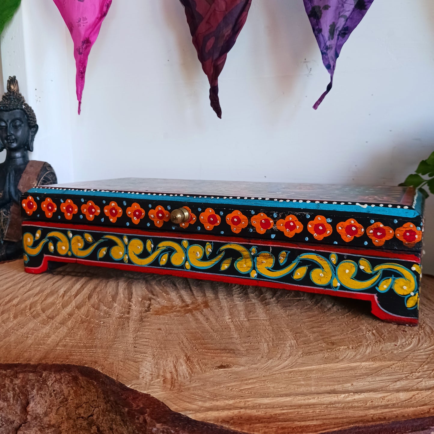 This beautiful hand painted sustainable mango wood box is ideal for keeping your jewellery or keepsakes in. The pretty peacock painting is framed with florals, as are the sides, and a little gold knob at the side for opening. A unique gift of colour and culture.