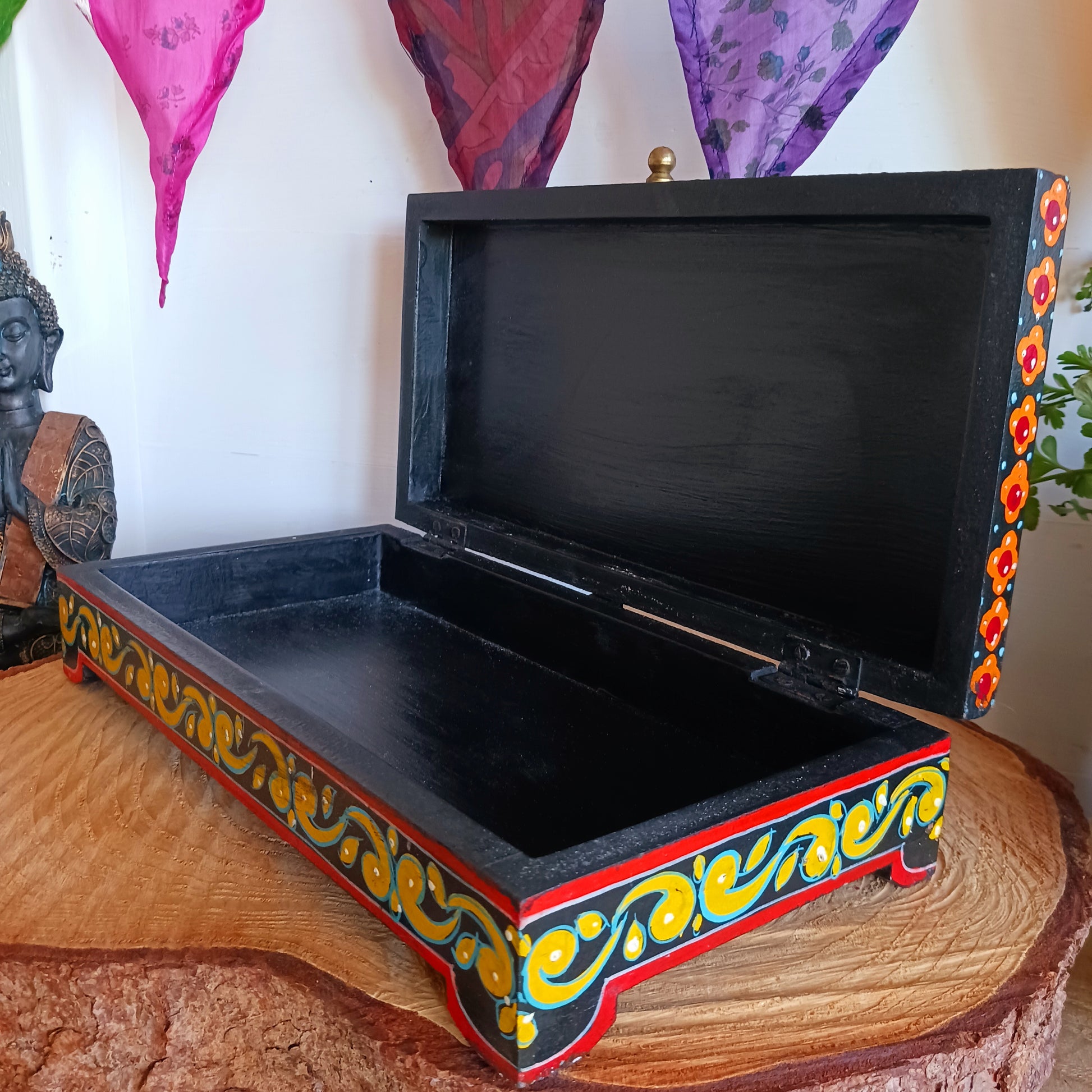 This beautiful hand painted sustainable mango wood box is ideal for keeping your jewellery or keepsakes in. The pretty peacock painting is framed with florals, as are the sides, and a little gold knob at the side for opening. A unique gift of colour and culture.