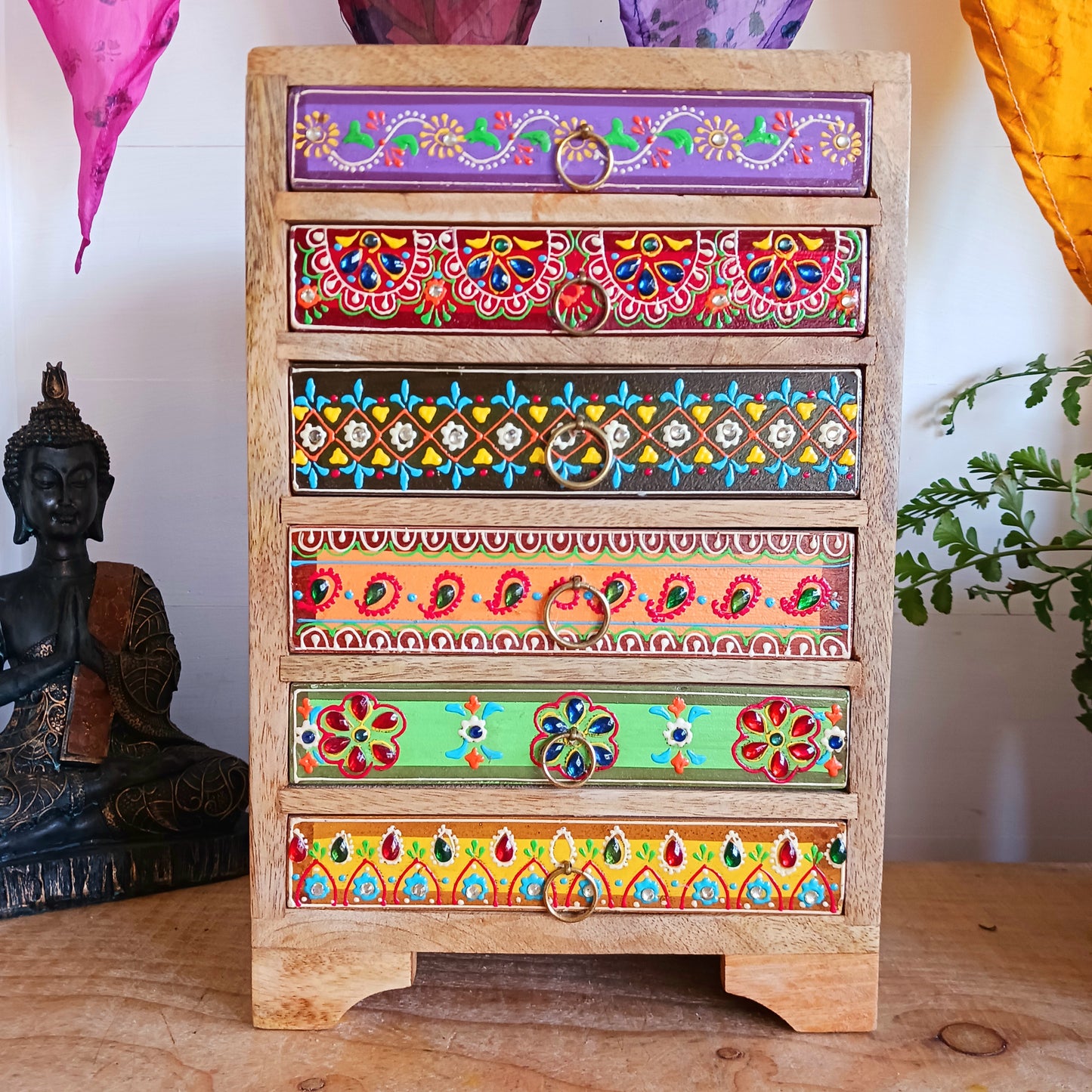 The Hindi word 'Sankalaka' is translated as 'eclectic'. The random applicaton of skillfully painted drawer panels results in this beautiful, eclectic, unique 6-drawer chest. Each panel is hand painted to perfection by highly skilled artisans. A beautiful addition to any home.