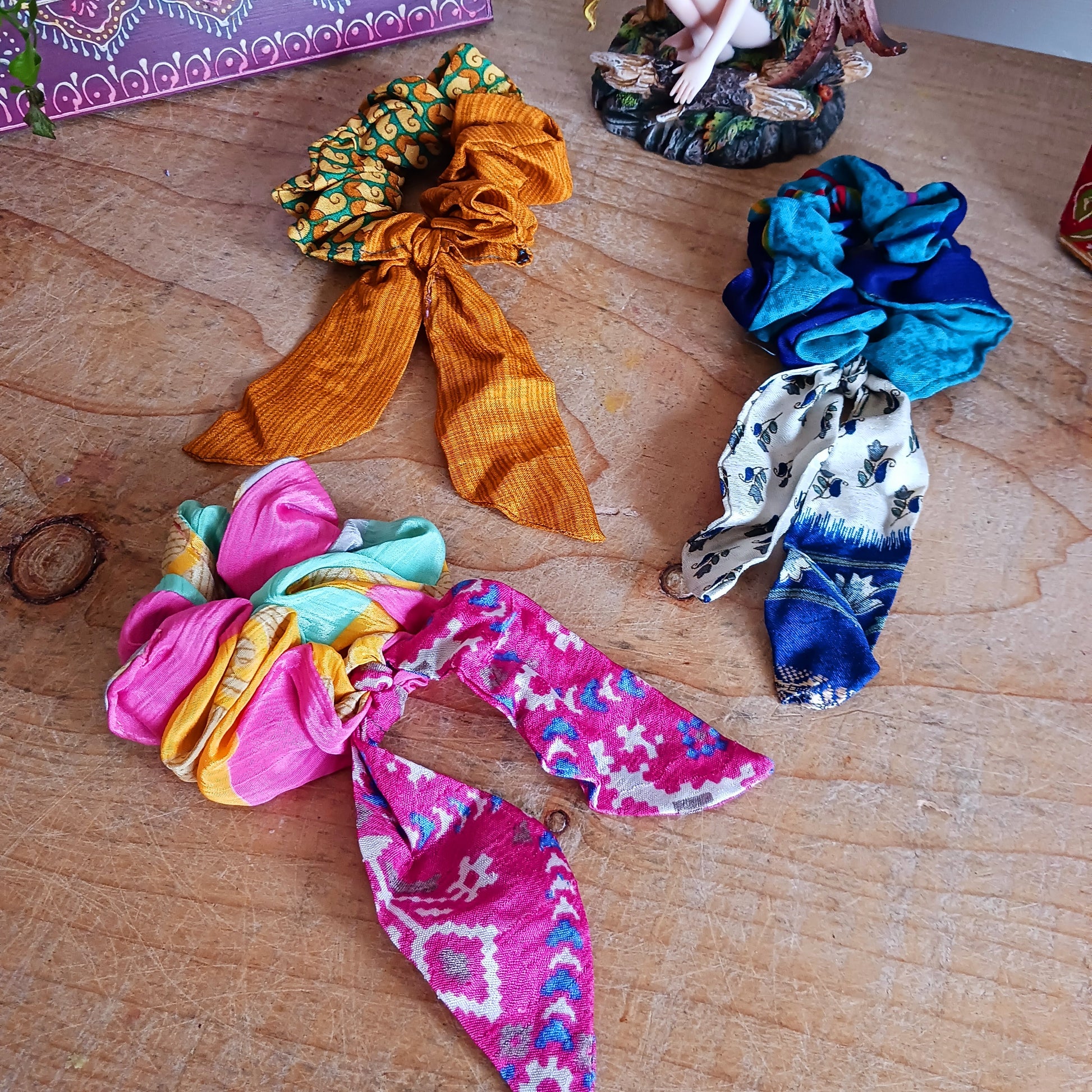 A silky sari material scrunchie styled with a trailing bow feature.  Glamorous sustainable fashion, these beautiful hair accessories come in assorted patterns and colours.